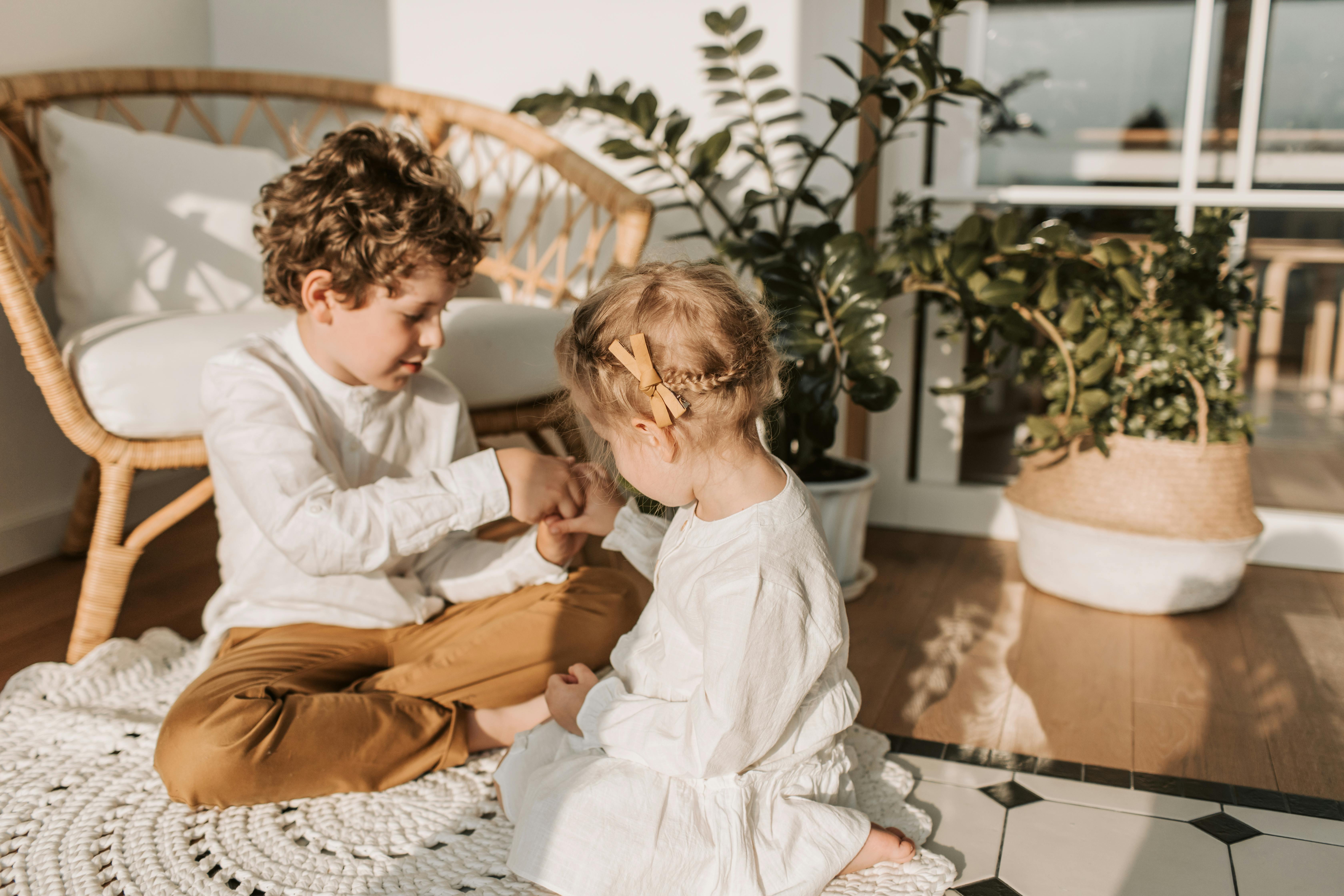 Des enfants assis par terre et jouant | Source : Pexels
