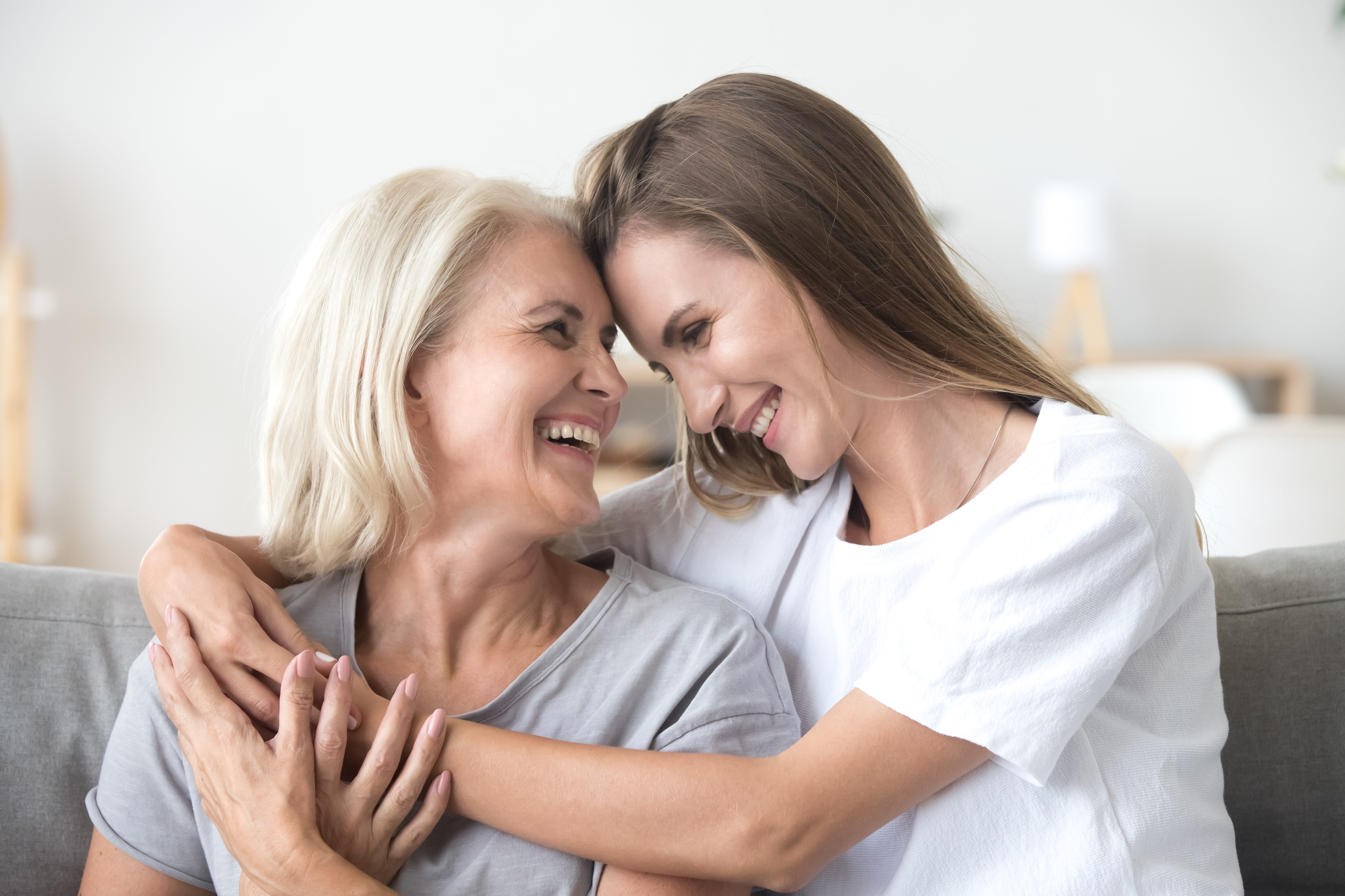 Une femme plus âgée et une femme plus jeune se font des câlins et rient | Source : Shutterstock
