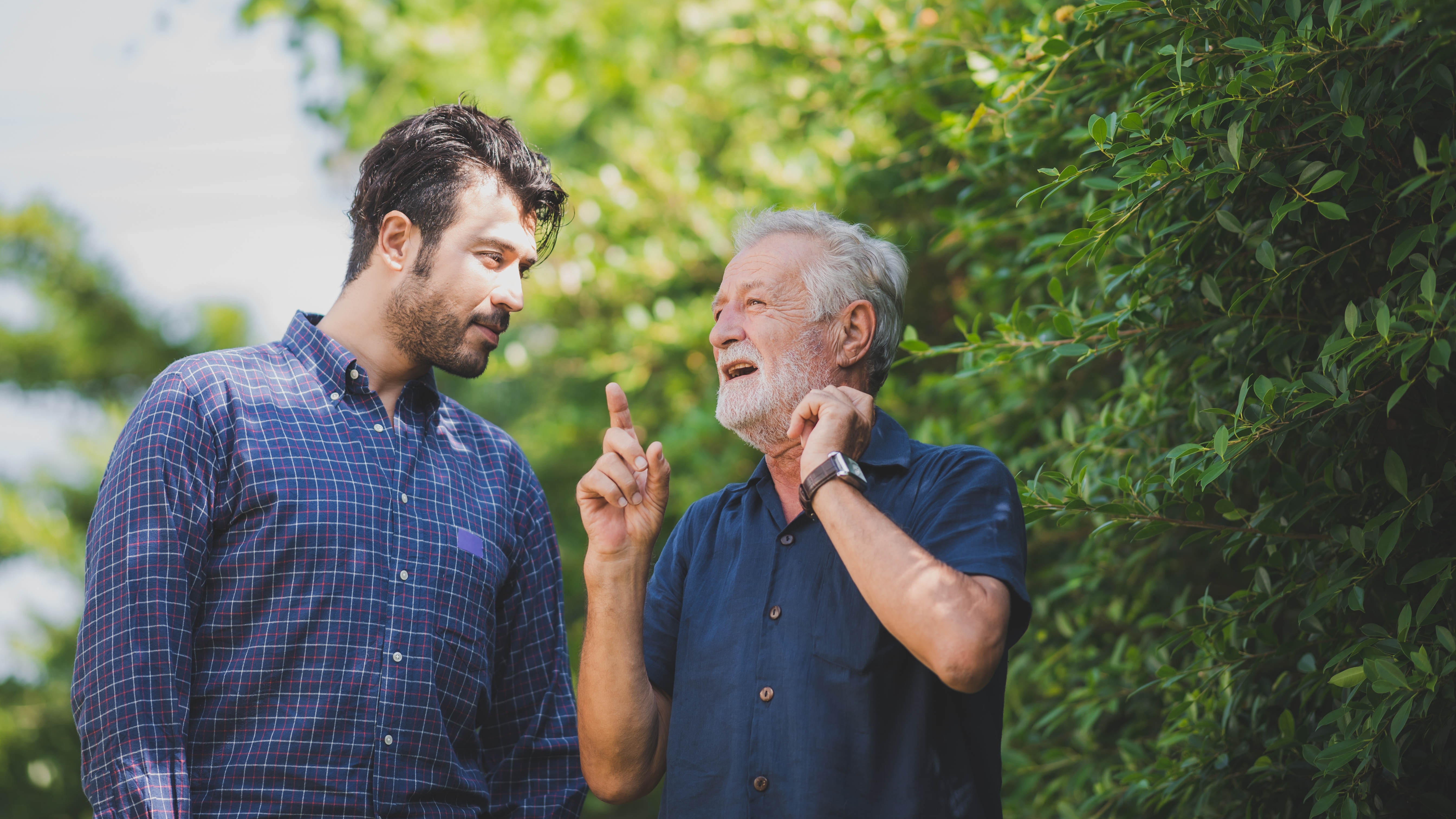 Un homme plus âgé discutant avec un homme plus jeune | Source : Shutterstock