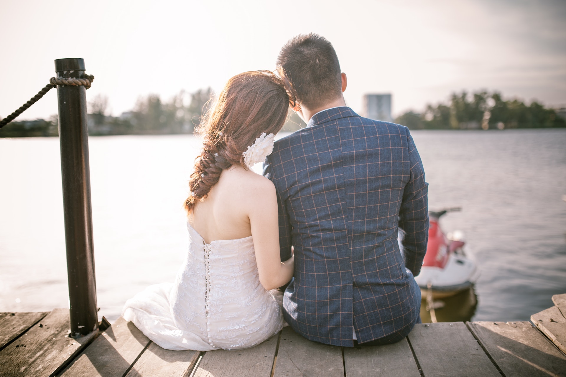 Les mariés assis sur un quai | Source : Pexels