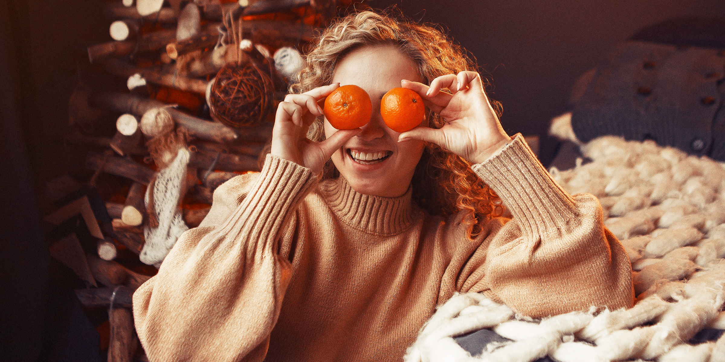 Une femme tenant des oranges devant ses yeux | Source : freepik.com/prostooleh