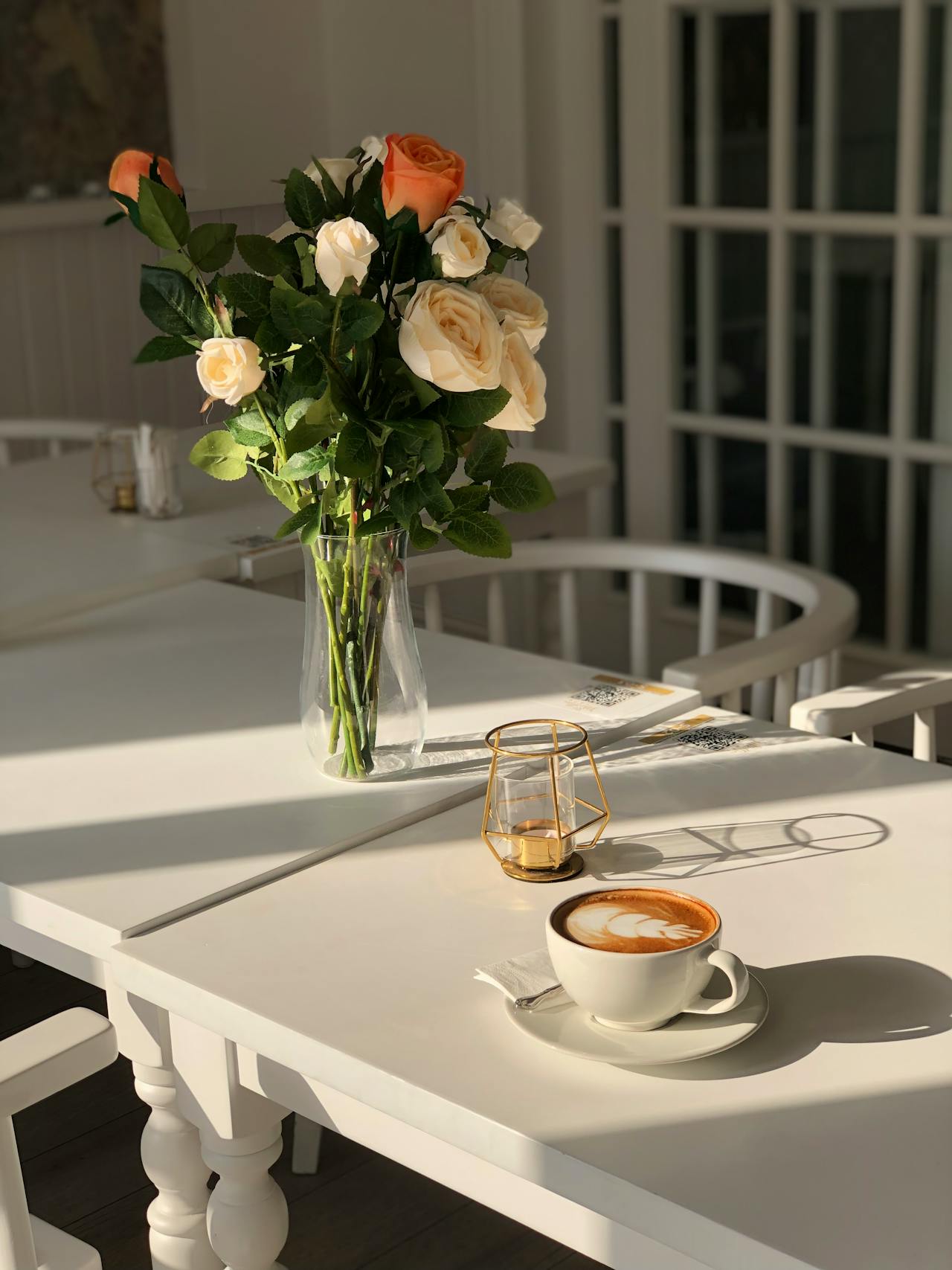 Un vase de fleurs et une tasse de café sur la table | Source : Pexels