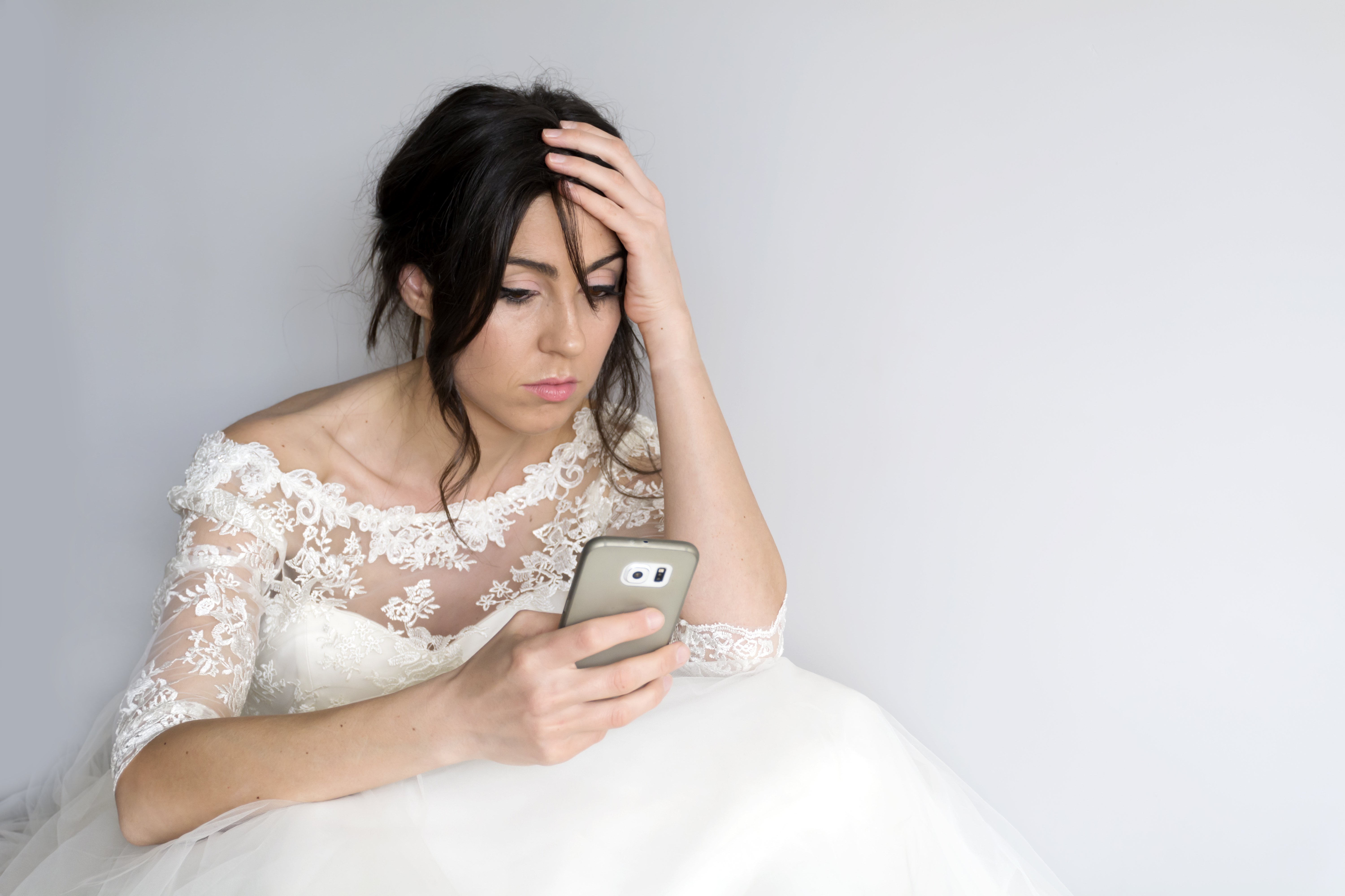 Une mariée triste qui regarde son téléphone | Source : Getty Images