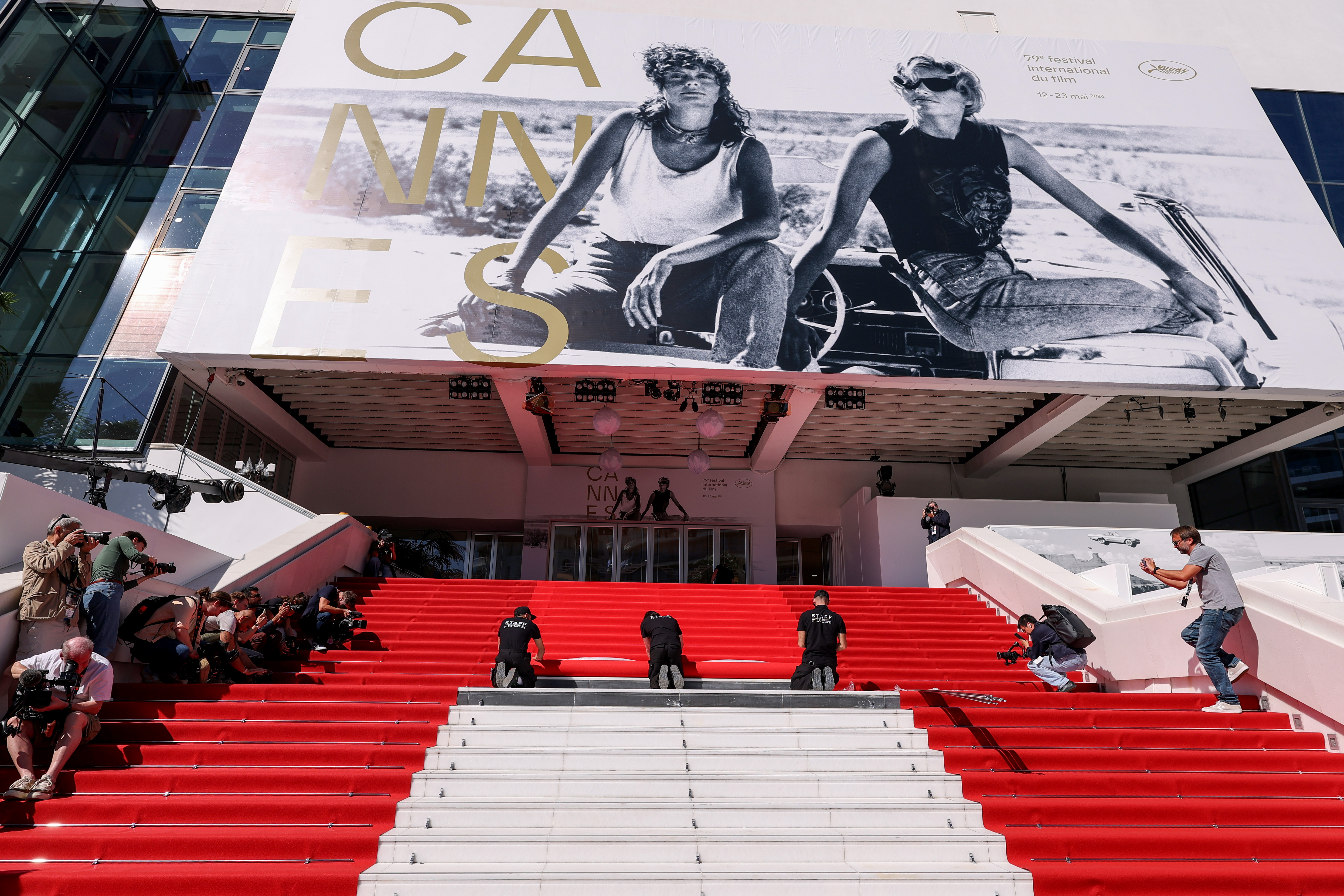 Des membres du personnel déroulent le tapis rouge en prévision de la 79e édition du Festival de Cannes, le 12 mai 2026 en France | Source : Getty Images