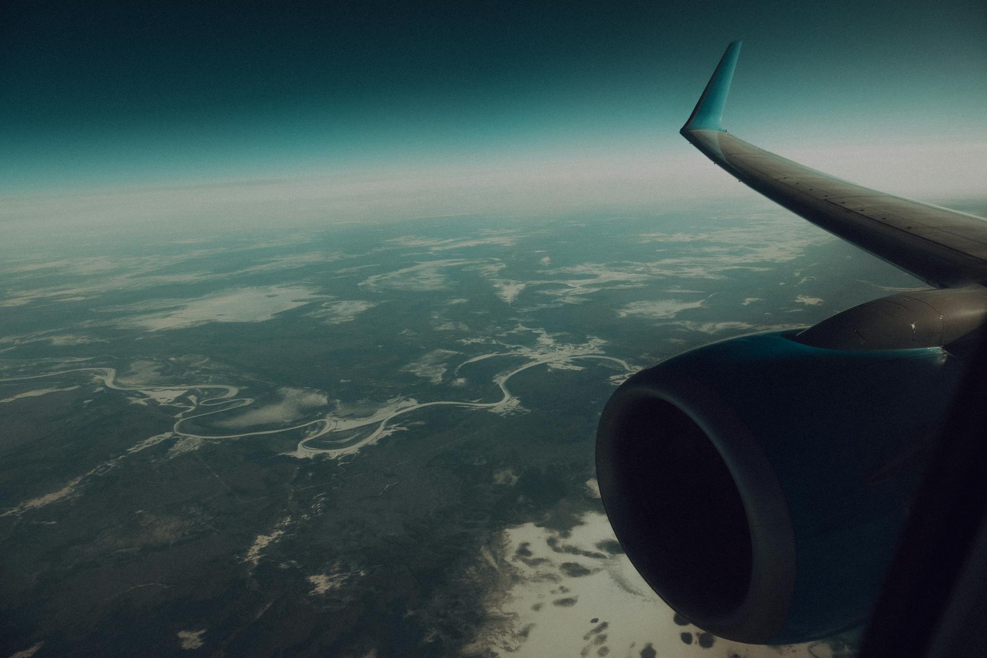 A plane flying over a field | Source: Pexels