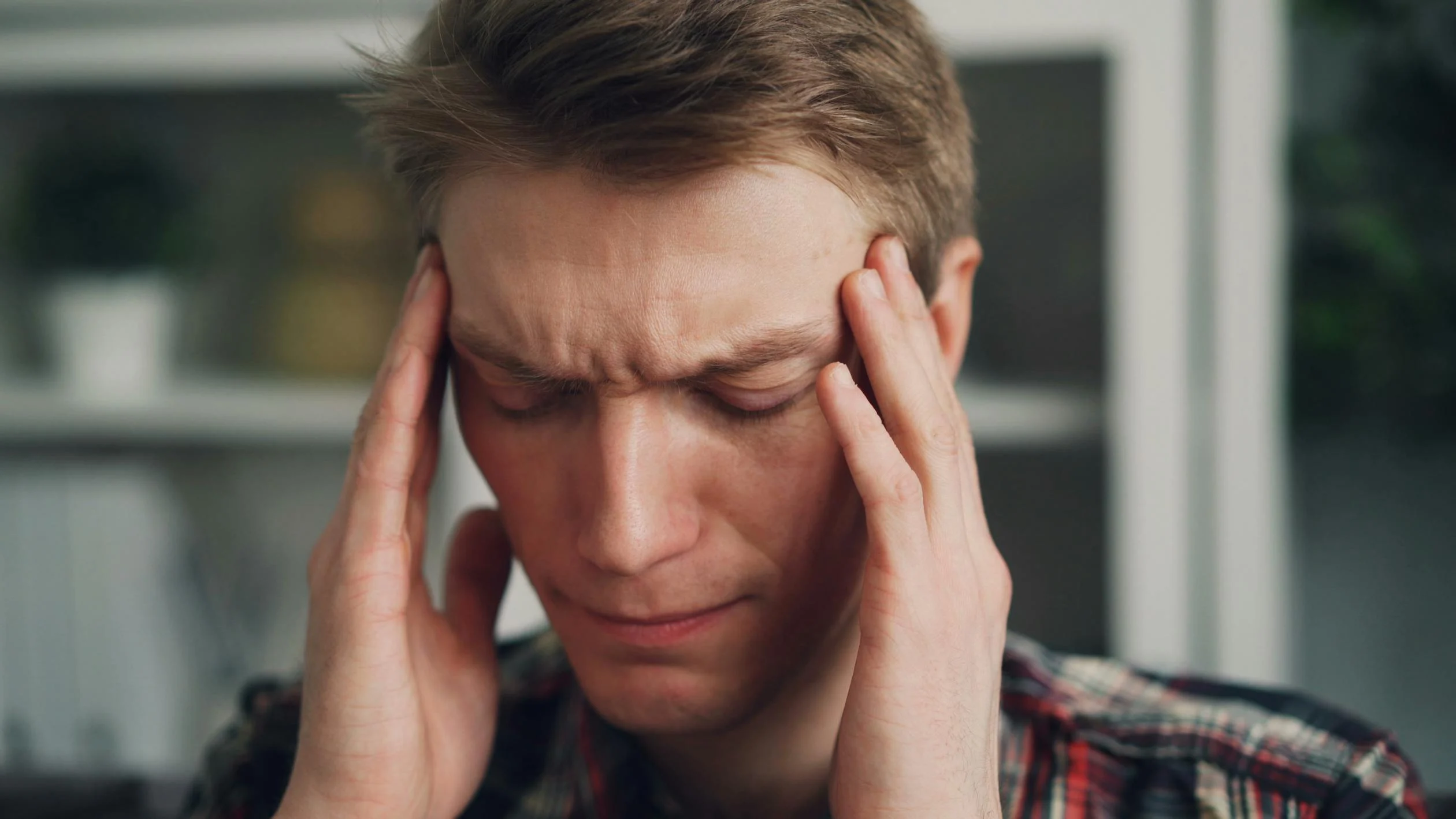 A tired man rubbing his temples | Source: Pexels