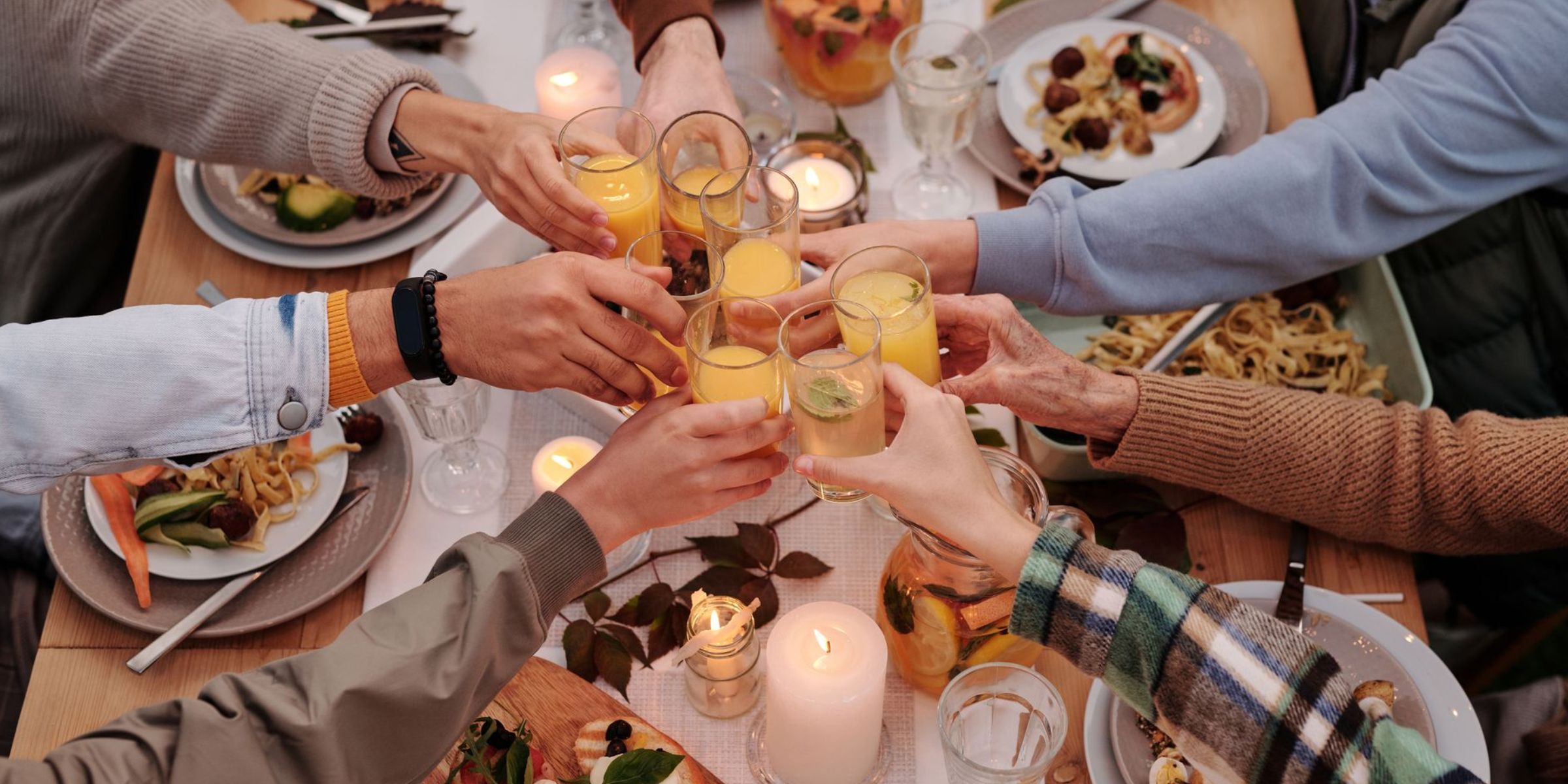 La famille et les amis qui trinquent ensemble autour d'un repas | Source : Pexels