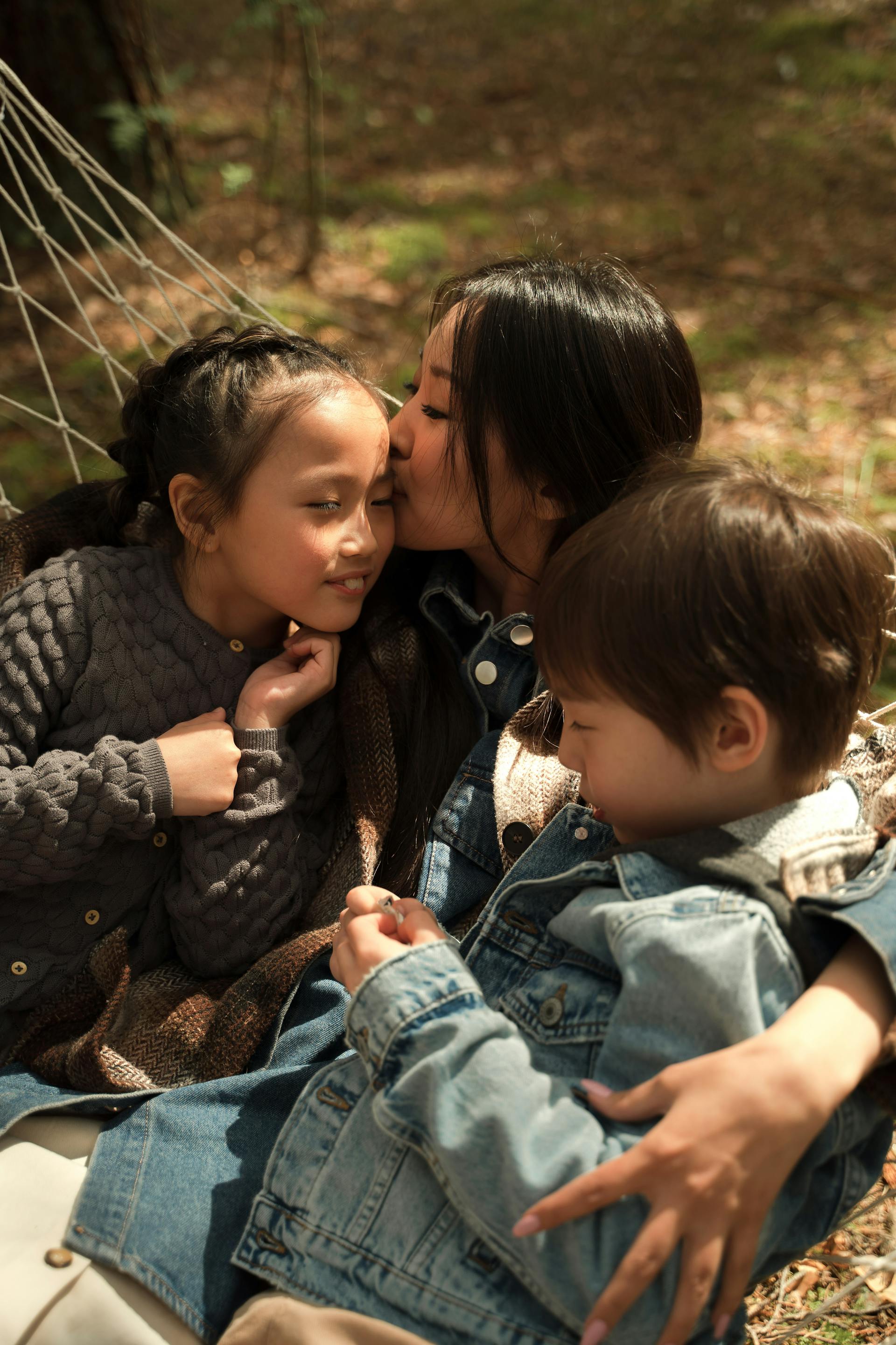 Une femme embrassant ses enfants | Source : Pexels