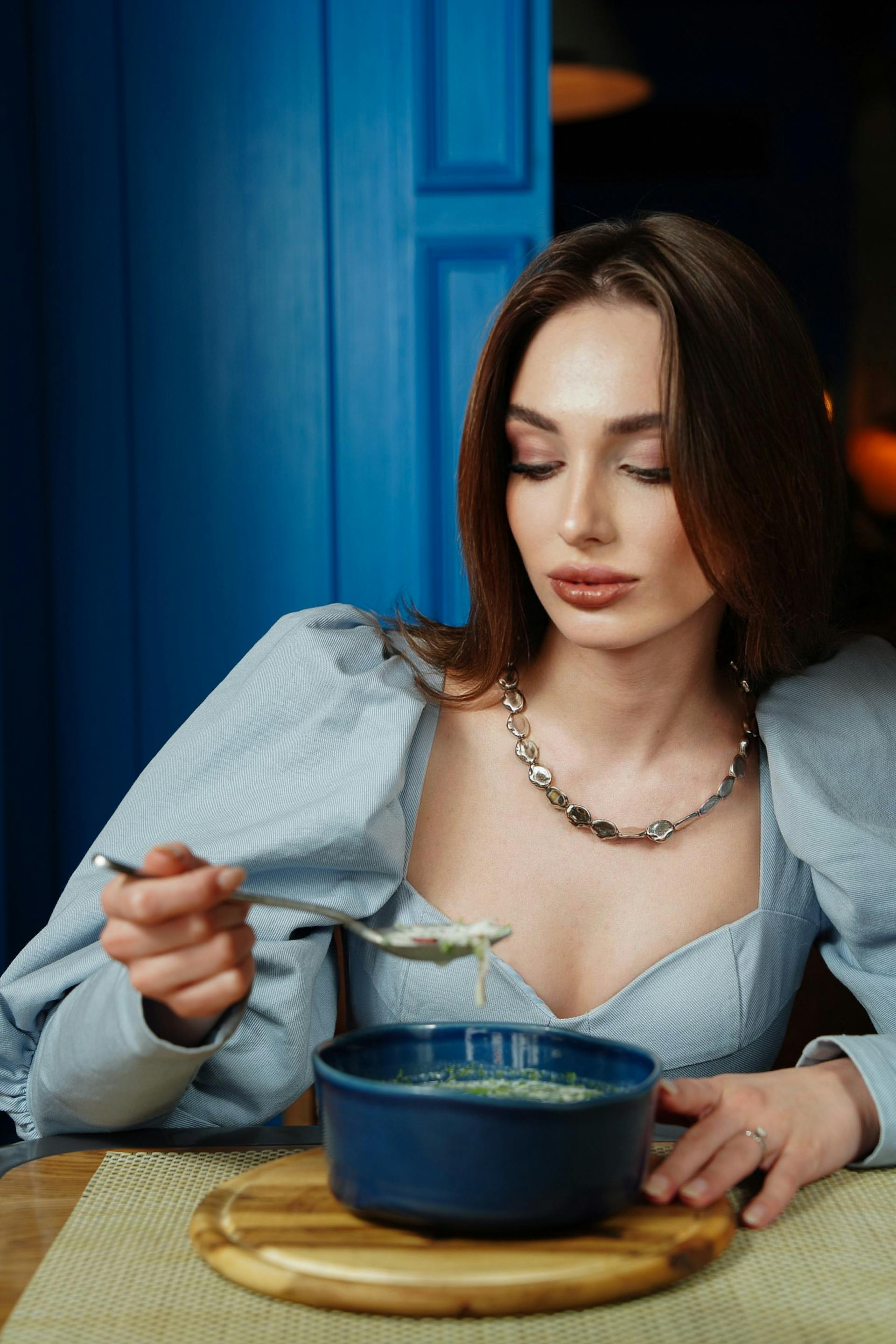 A woman looking at her meal doubtfully | Source: Pexels