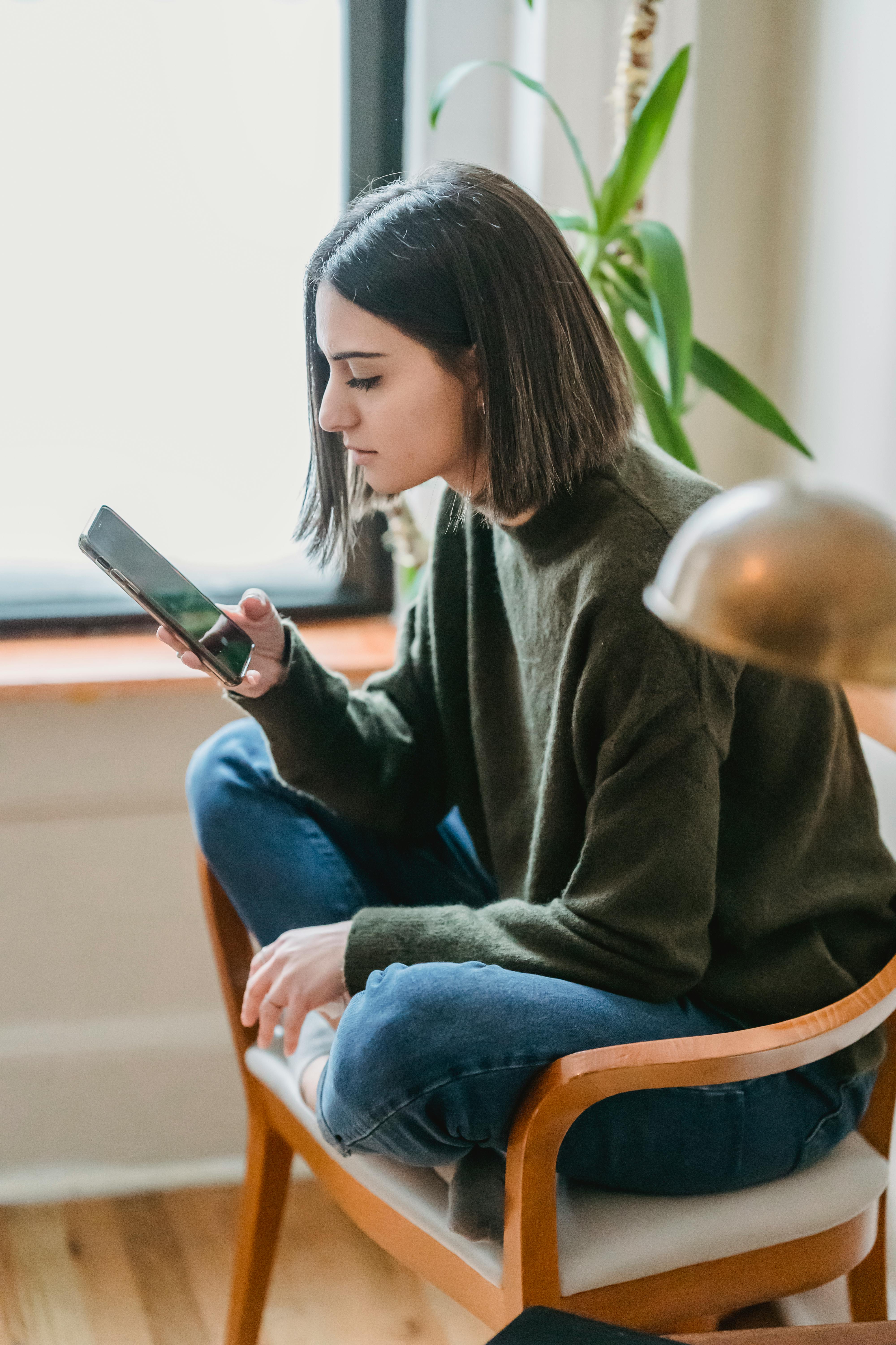 Une femme qui fait défiler son téléphone | Source : Pexels