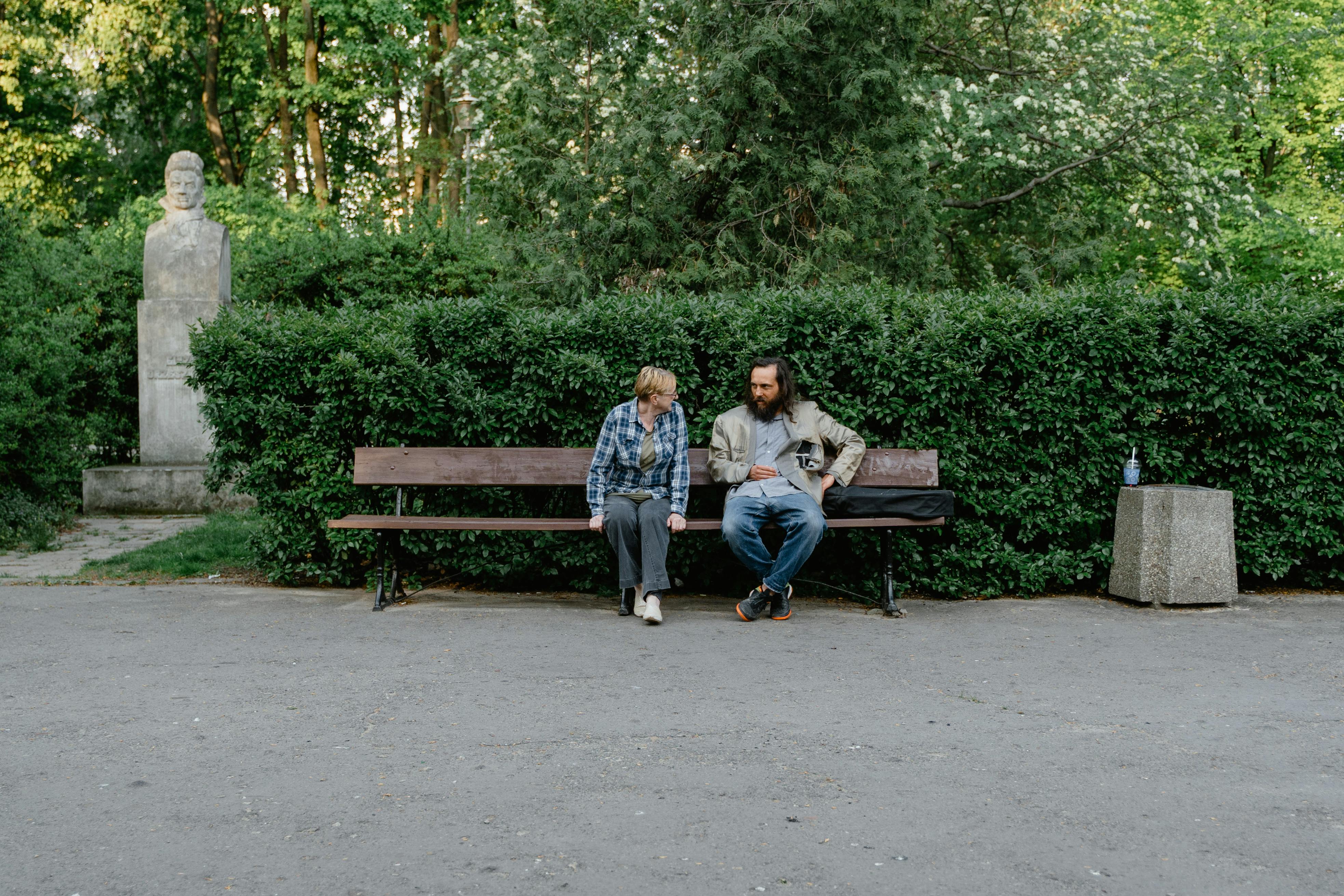 Une femme parle à un homme démuni dans un parc | Source : Pexels