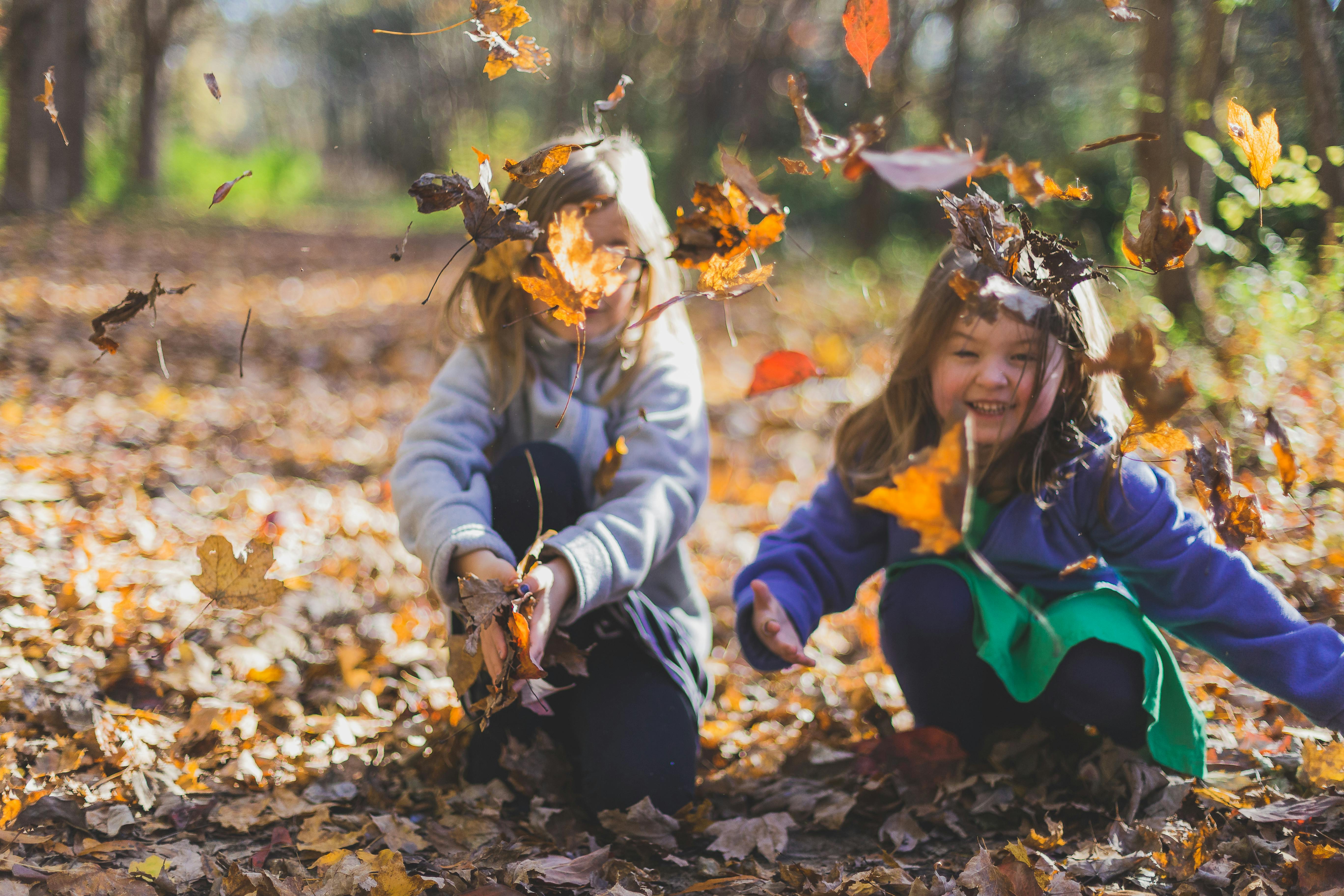 Enfants jouant dans les feuilles qui tombent | Source : Pexels