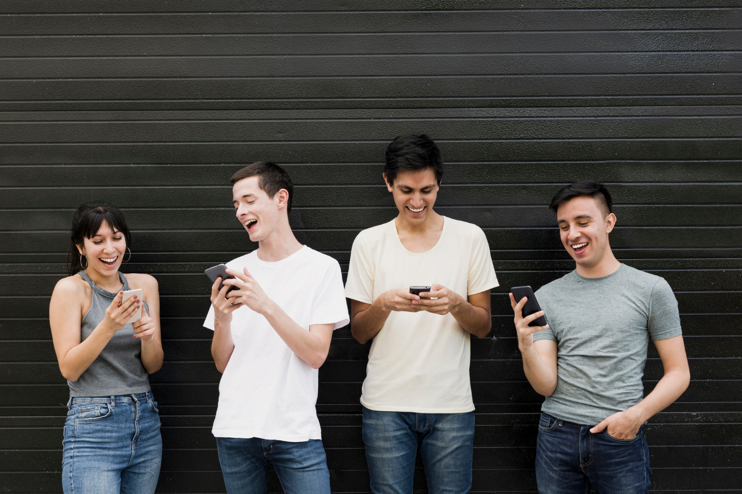 Un groupe de personnes excitées tenant leur téléphone portable | Source : Freepik
