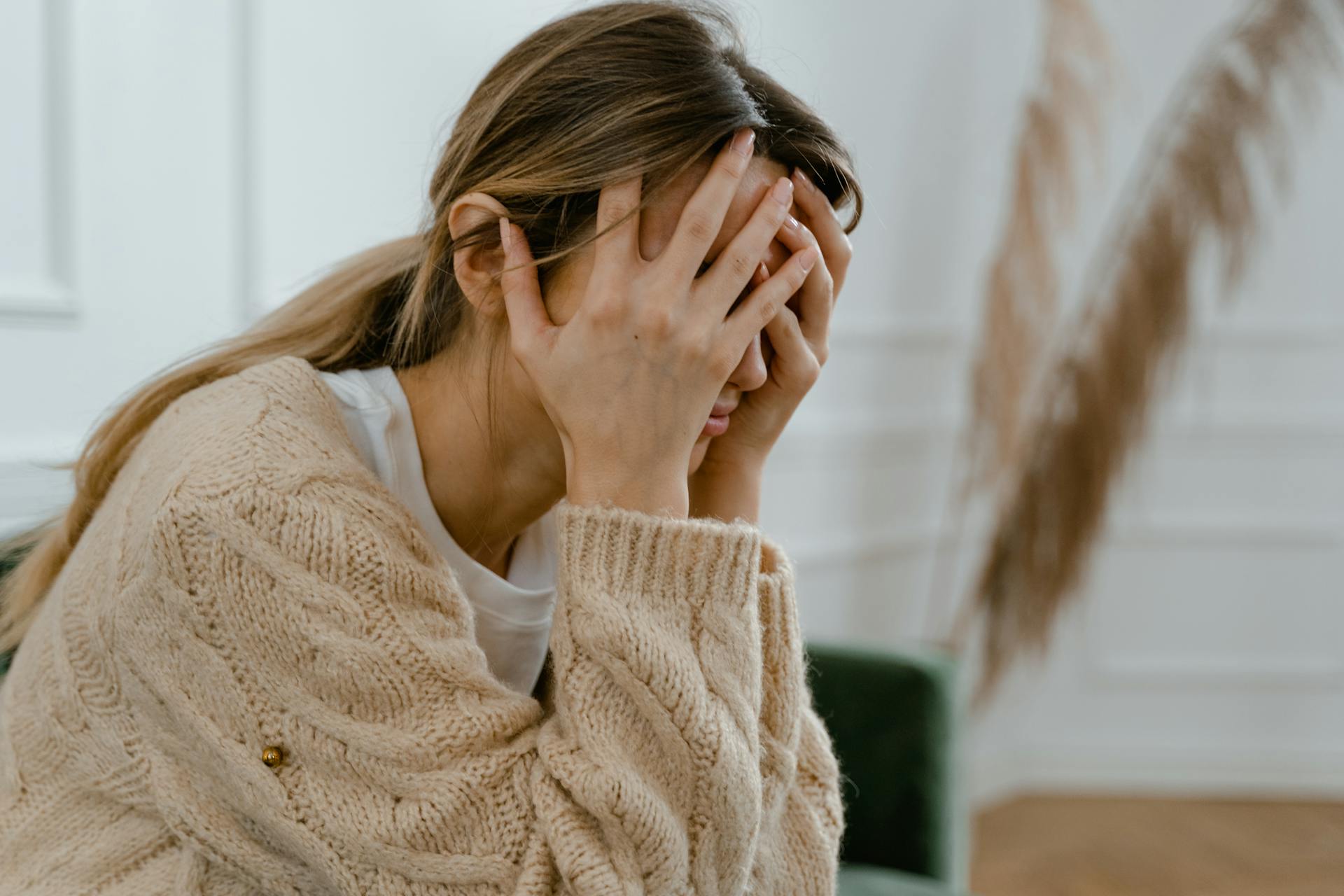 Une femme assise, les mains couvrant son visage | Source : Pexels