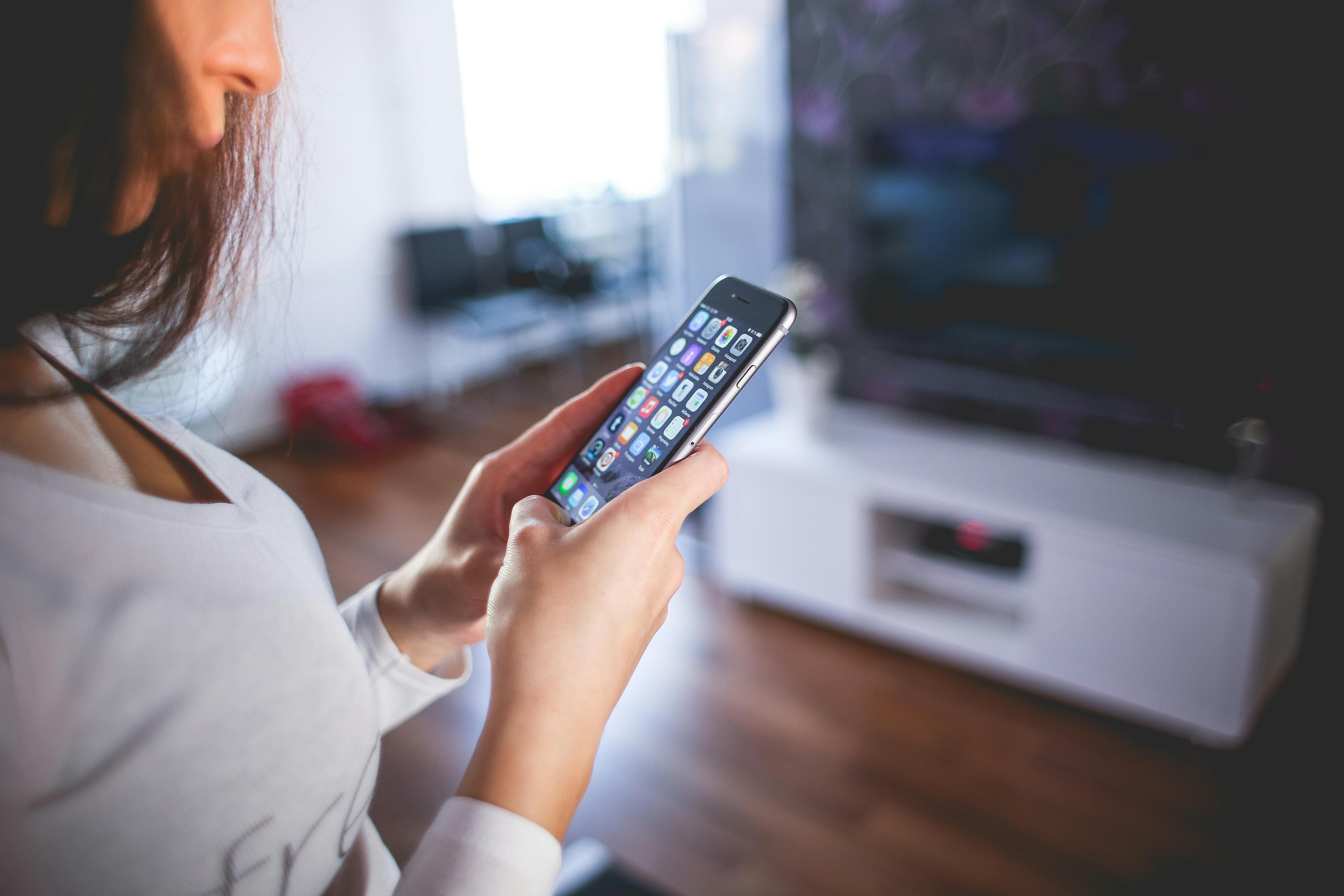 Une femme inspecte son téléphone portable | Source : Pexels