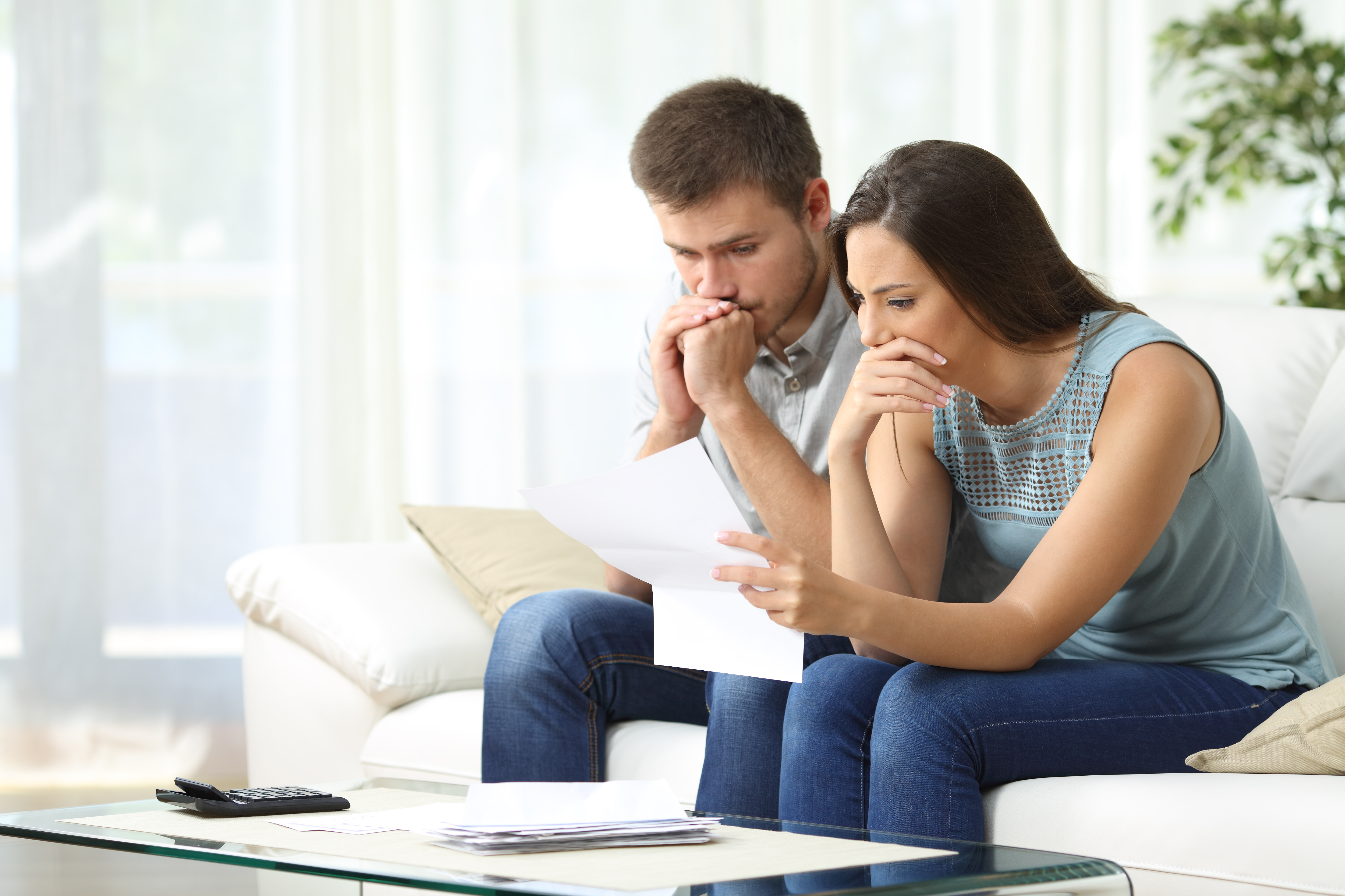 Un couple inquiet regarde un document | Source : Shutterstock