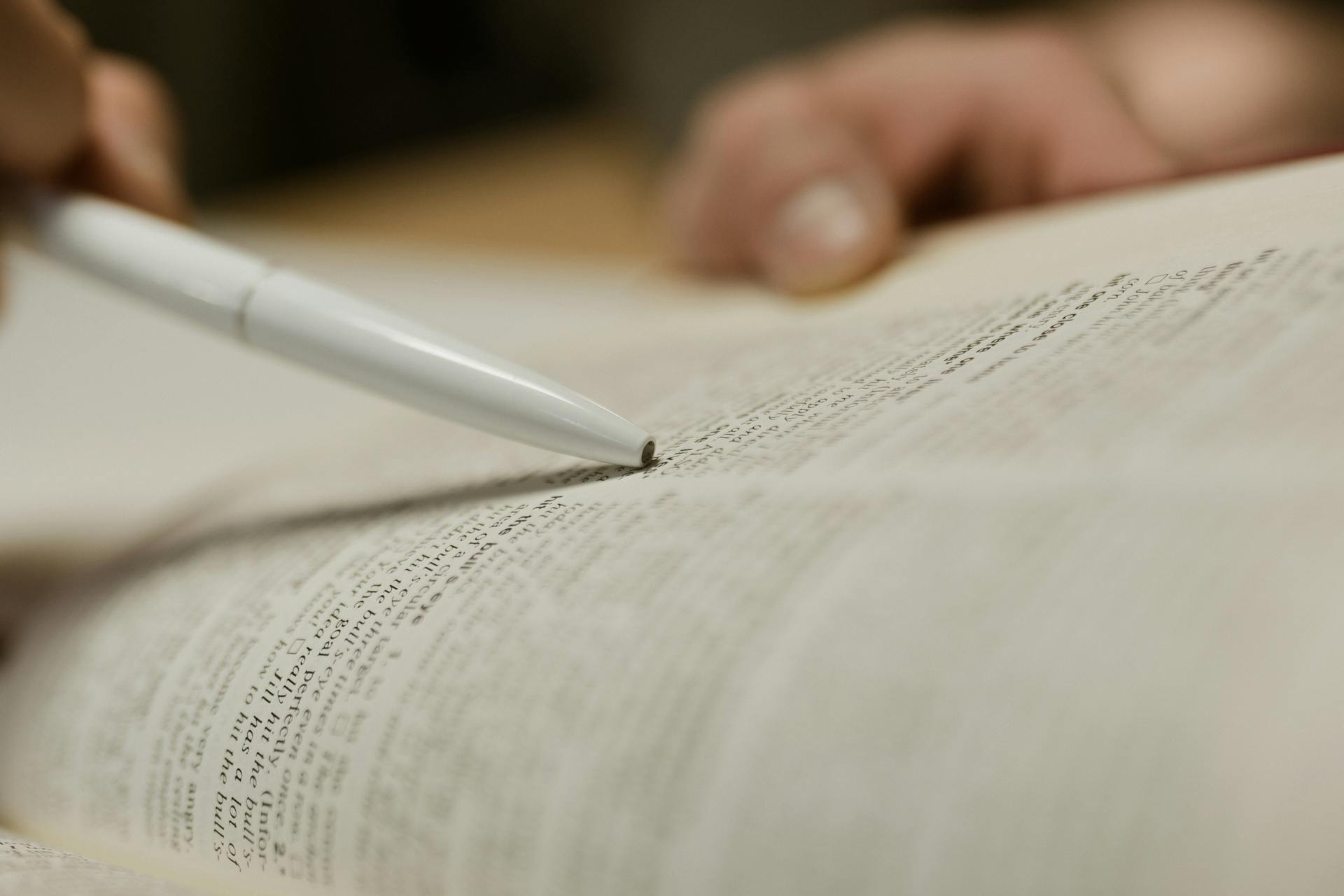Une personne étudiant un texte dans un livre | Source : Pexels