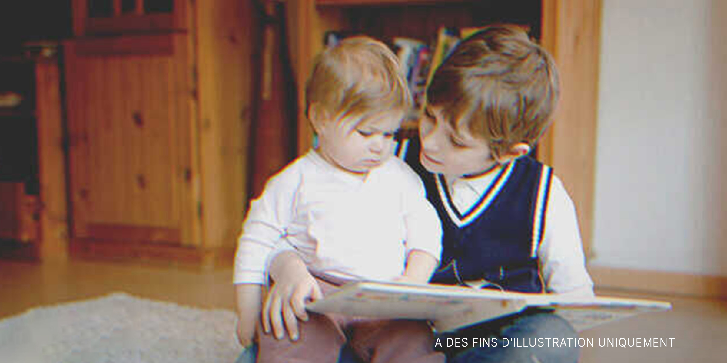 Deux enfants regardant un livre | Source : Shutterstock