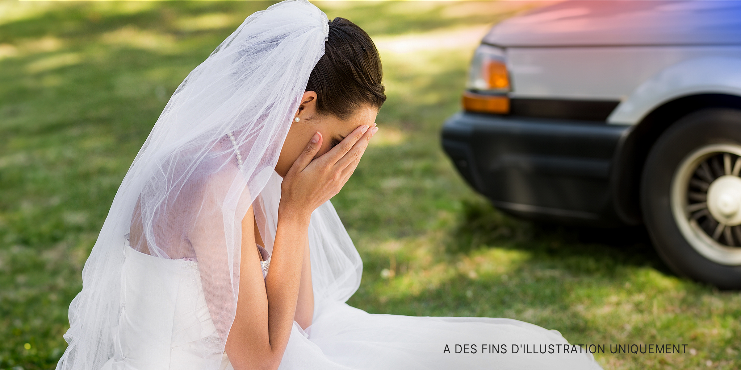 Une mariée assise à l'extérieur, le visage enfoui dans ses mains | Source : Shutterstock