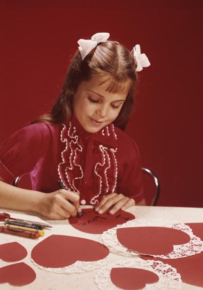 Une petite fille qui fait des carte de vœux. | Photo : Getty Images