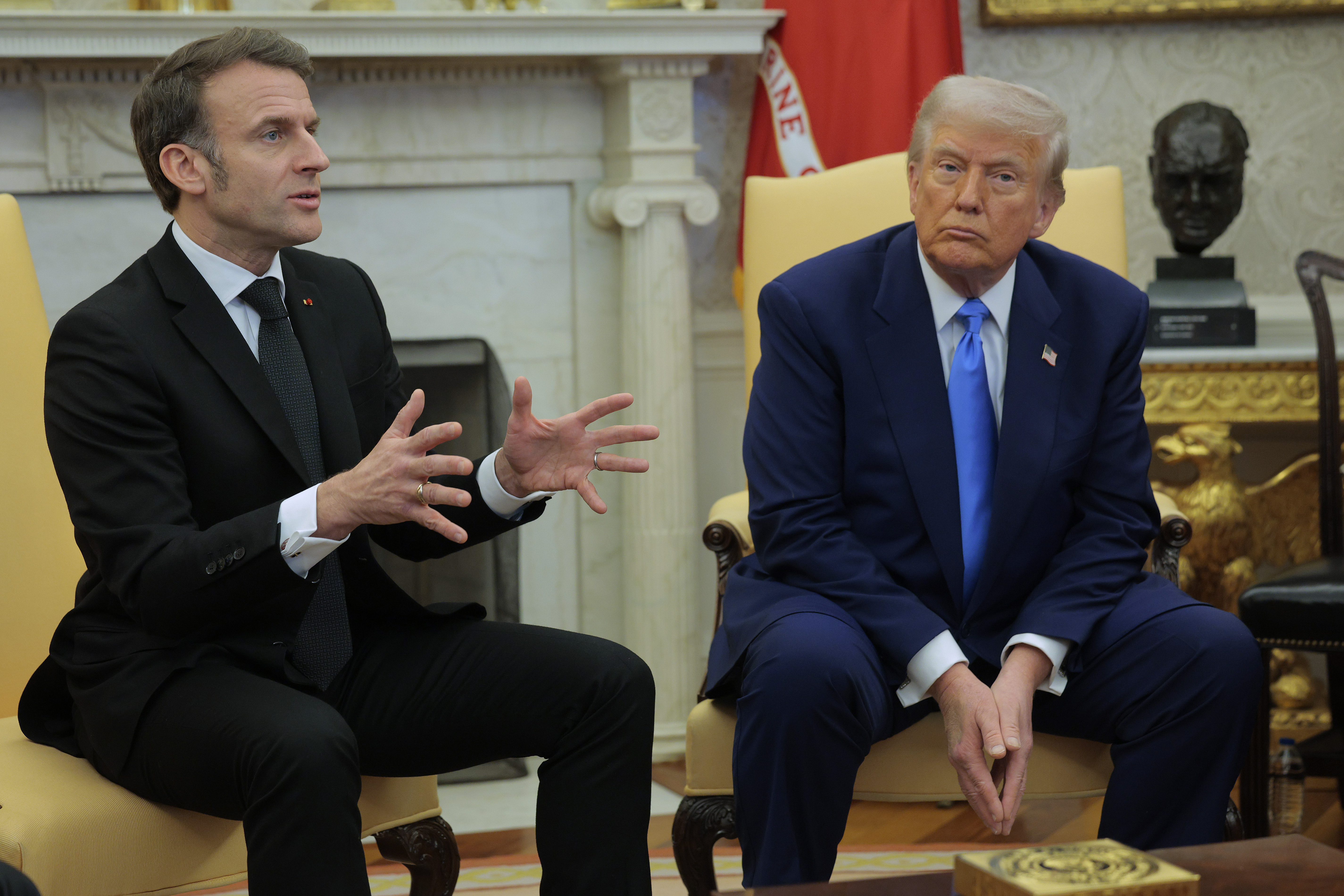 Donald Trump écoute Emmanuel Macron répondre à la question d'un journaliste dans le bureau ovale de la Maison Blanche à Washington, DC, le 24 février 2025 | Source : Getty Images