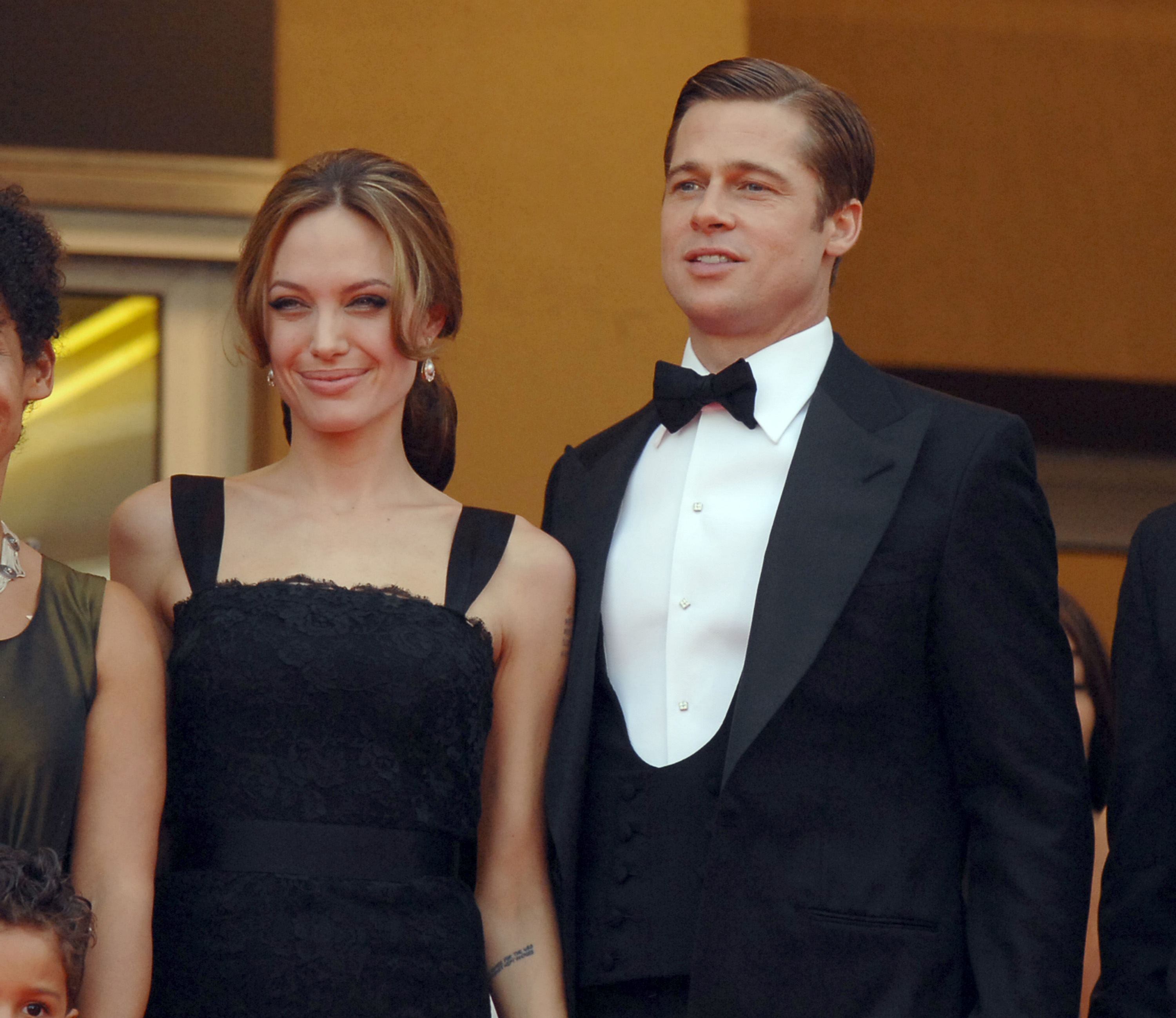 Angelina Jolie sourit aux côtés de Brad Pitt alors que le couple fait son apparition en tenue de soirée noire assortie lors de la première du film « A Mighty Heart » au Festival de Cannes, en France.