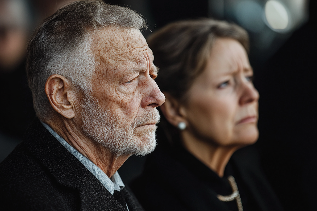 Un couple d'âge mûr lors d'une réception funéraire | Source : Midjourney