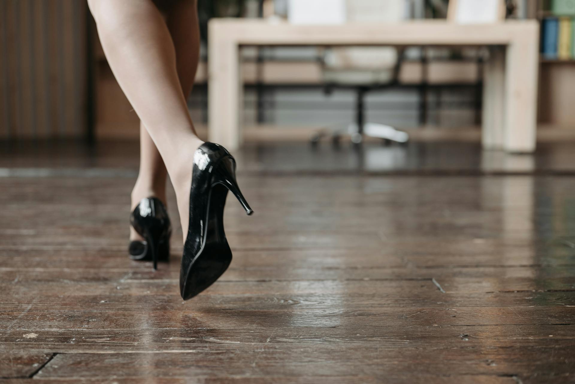 A woman walking on a wooden floor | Source: Pexels