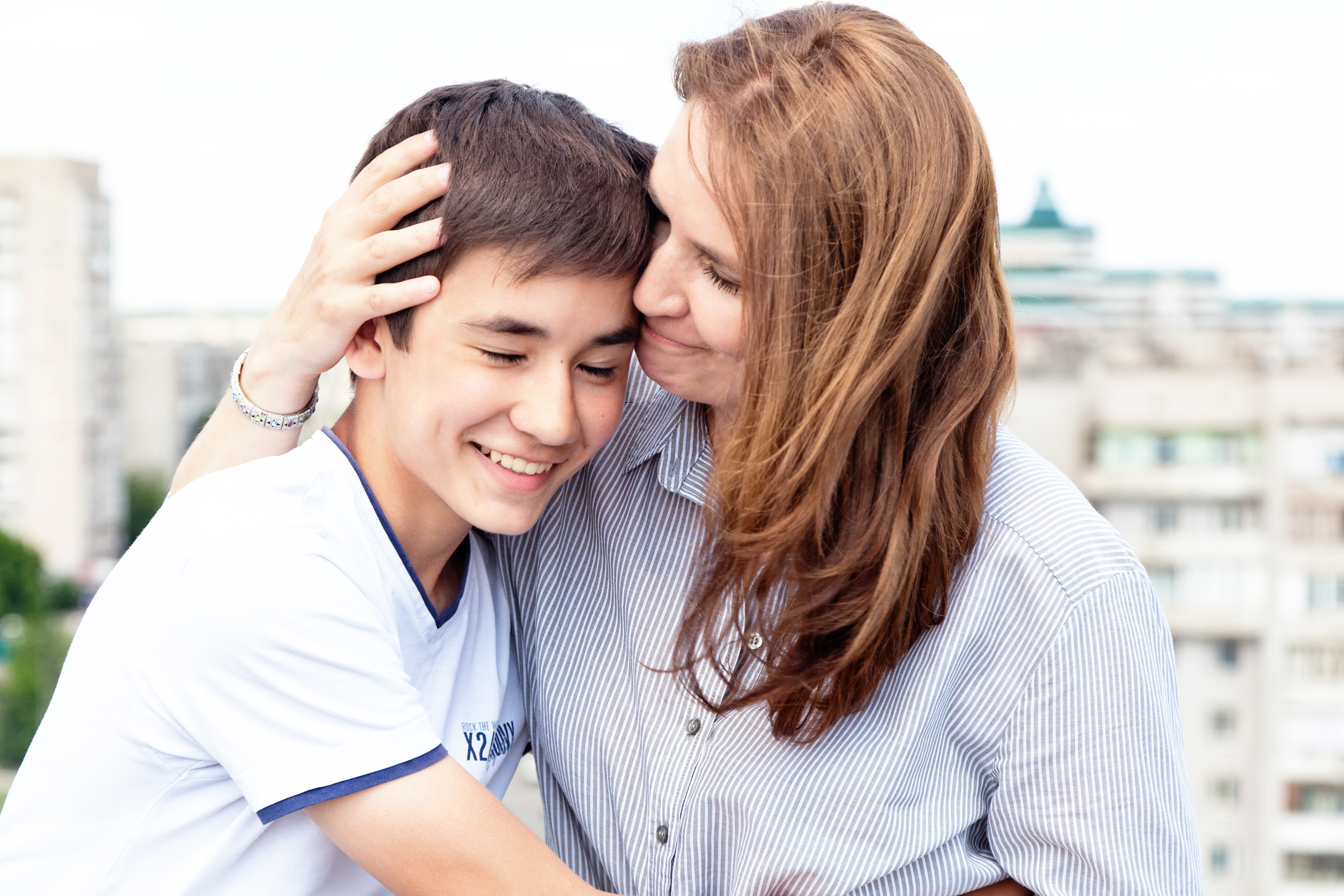 Mère serrant son fils adolescent dans ses bras | Source : Shutterstock