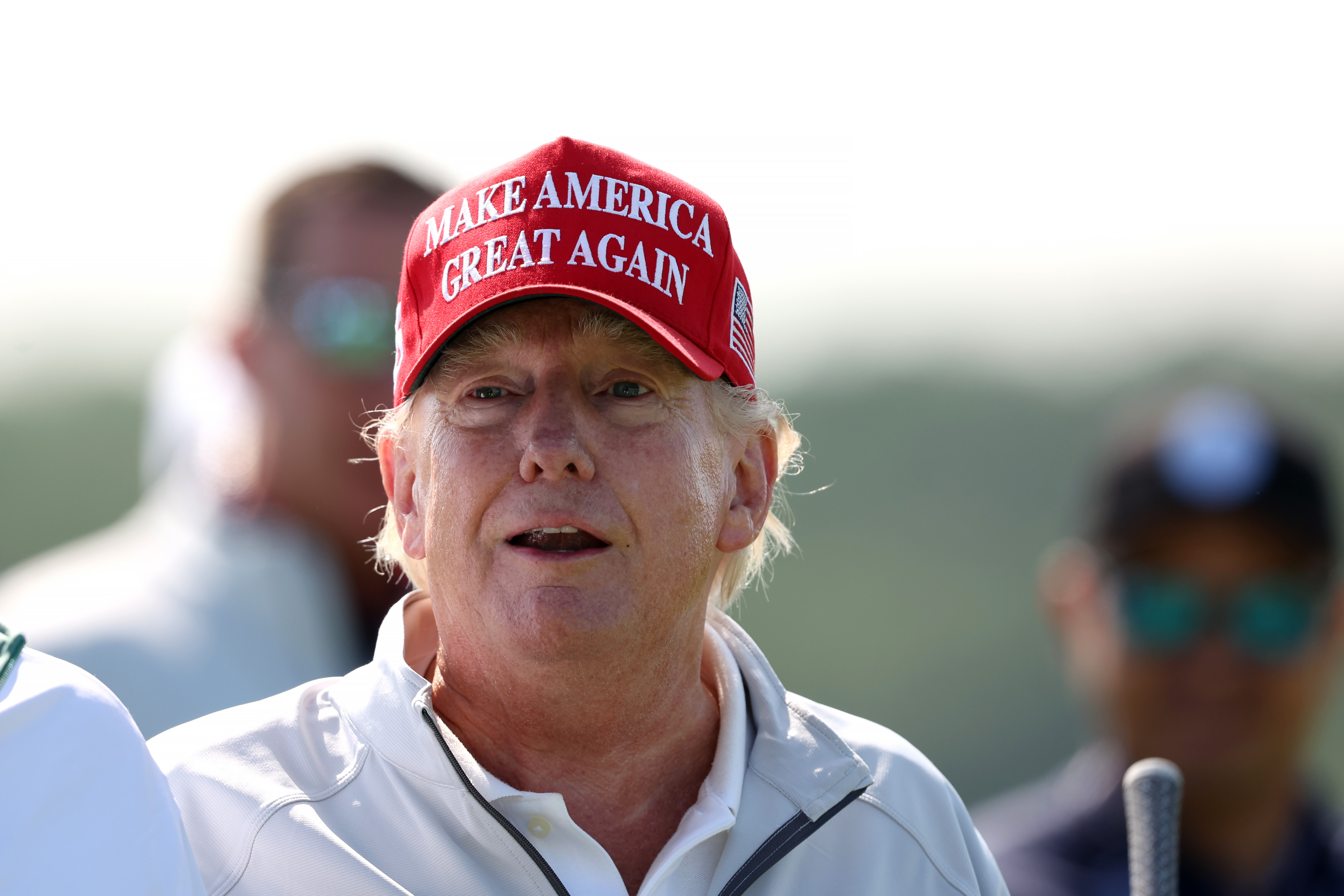 Lors du LIV Golf Invitational à Sterling, en Virginie, le 25 mai, Donald Trump se tient au soleil, vêtu d'une casquette rouge