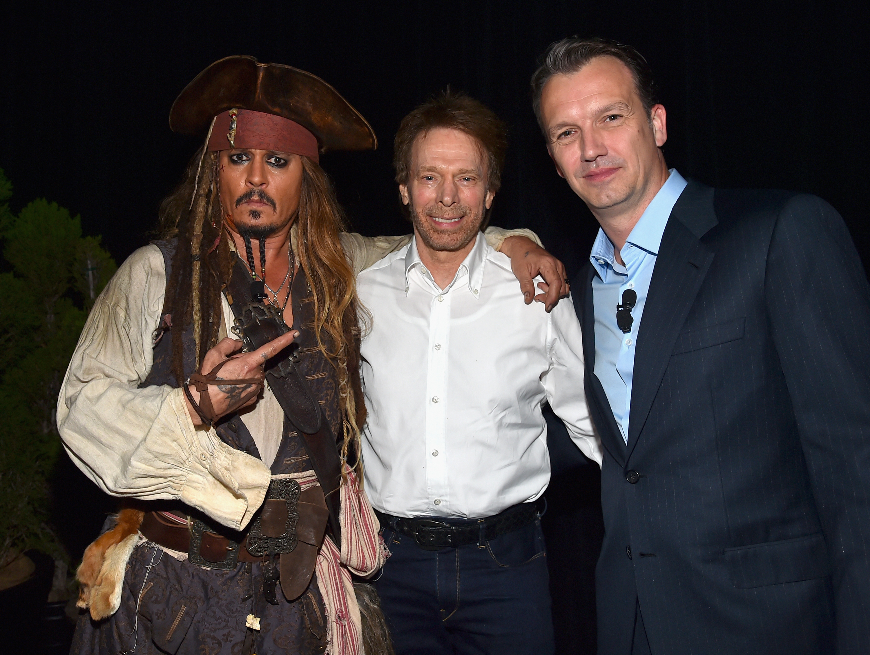 Johnny Depp dans le rôle du capitaine Jack Sparrow, avec Jerry Bruckheimer et Sean Bailey lors de la présentation "Worlds, Galaxies, and Universes : Live Action at The Walt Disney Studios" lors de la présentation à la D23 Expo à Anaheim, en Californie, le 15 août 2015 | Source : Getty Images