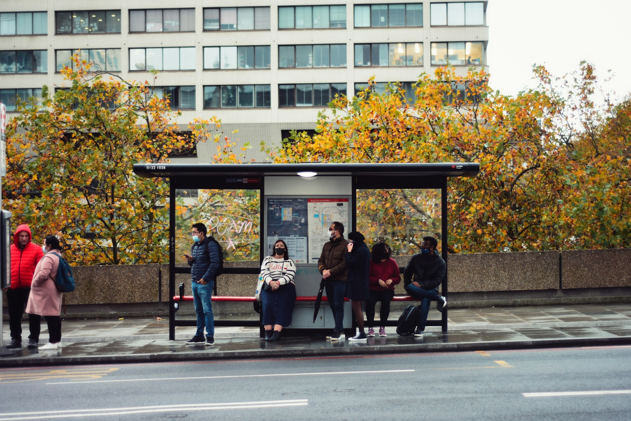 Des gens attendent le bus à un arrêt de bus | Source : Unsplash