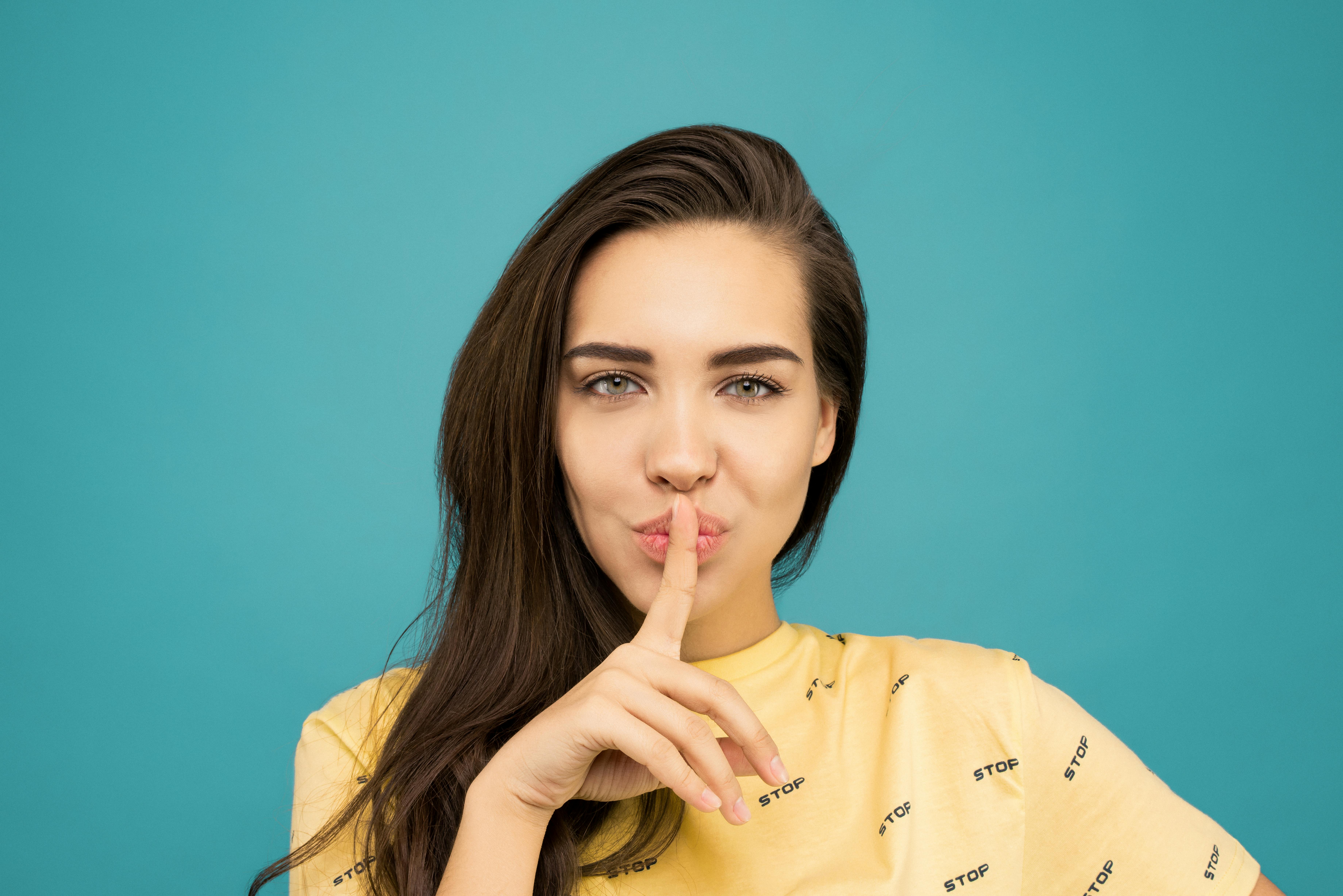 A woman with her finger on her mouth | Source: Pexels