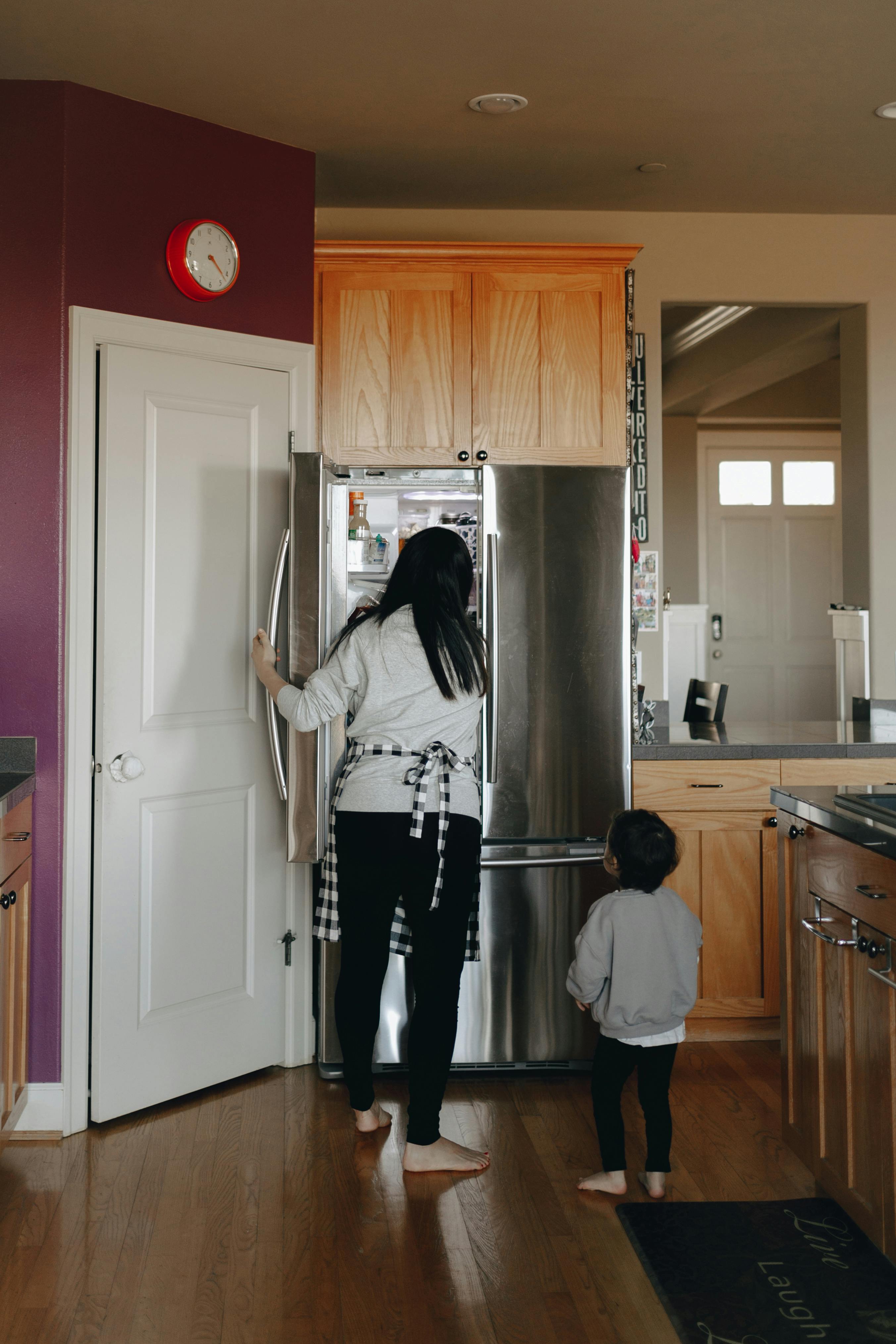 Jeune fille avec sa mère dans la cuisine. | Source : Pexels