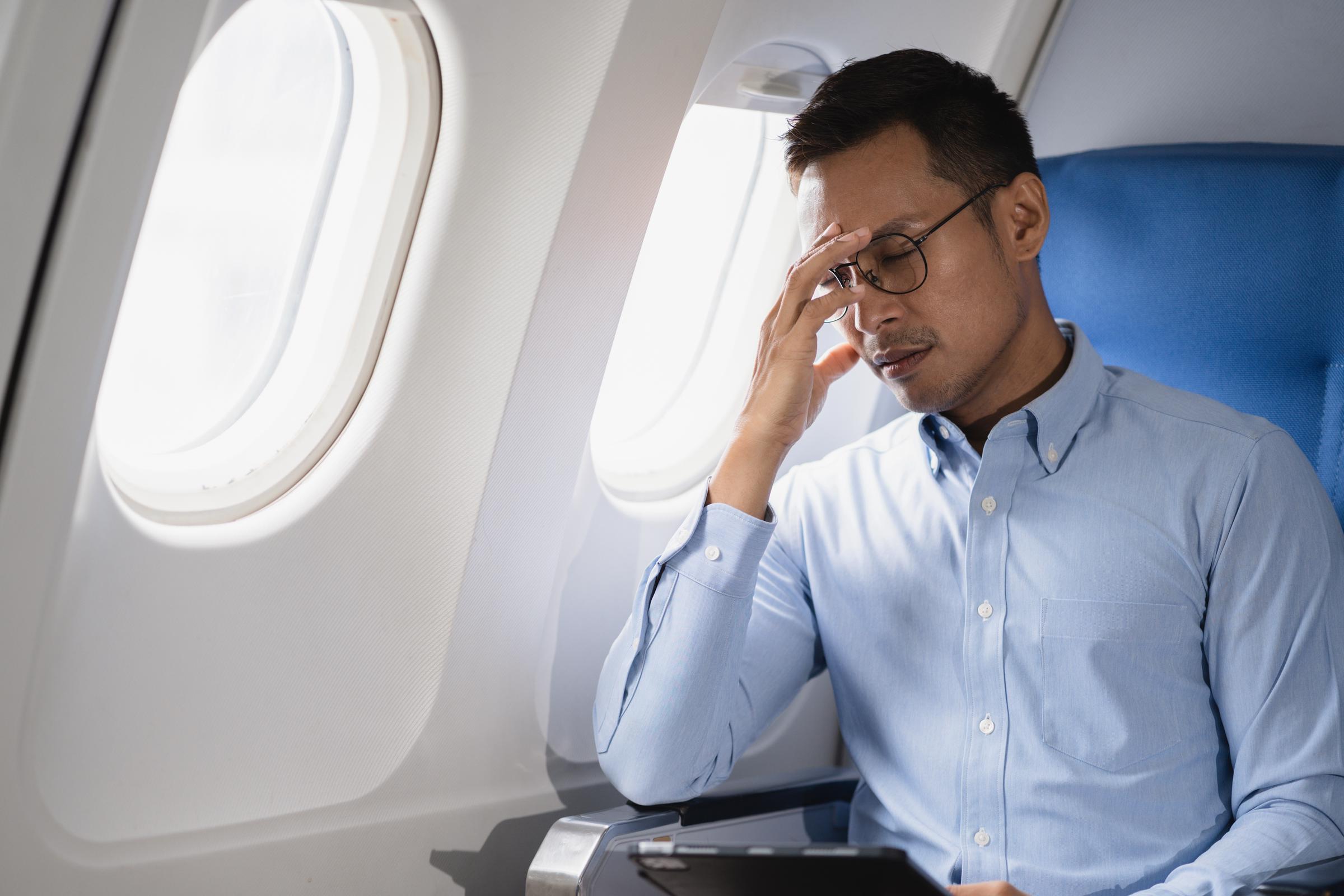 Homme embarrassé à l'intérieur d'un avion | Source : Shutterstock