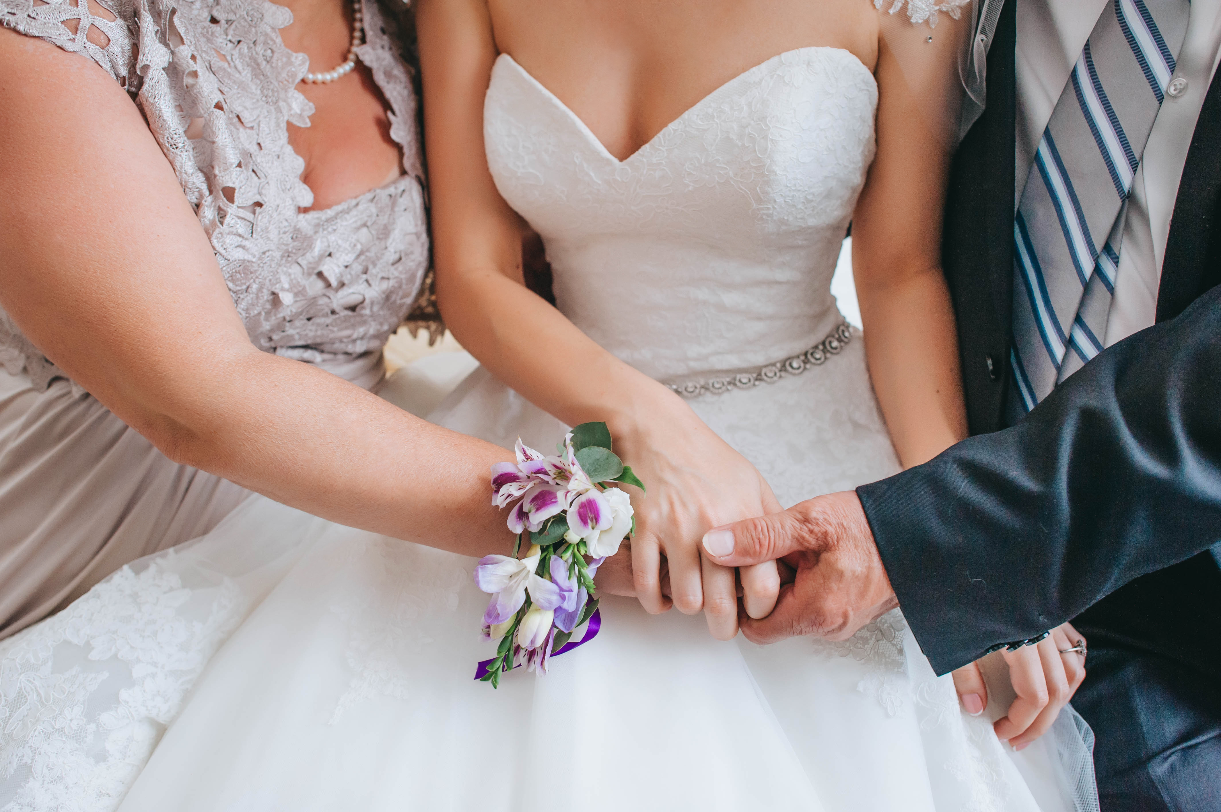 Parents tenant la main de leur fille le jour de son mariage | Source : Shutterstock