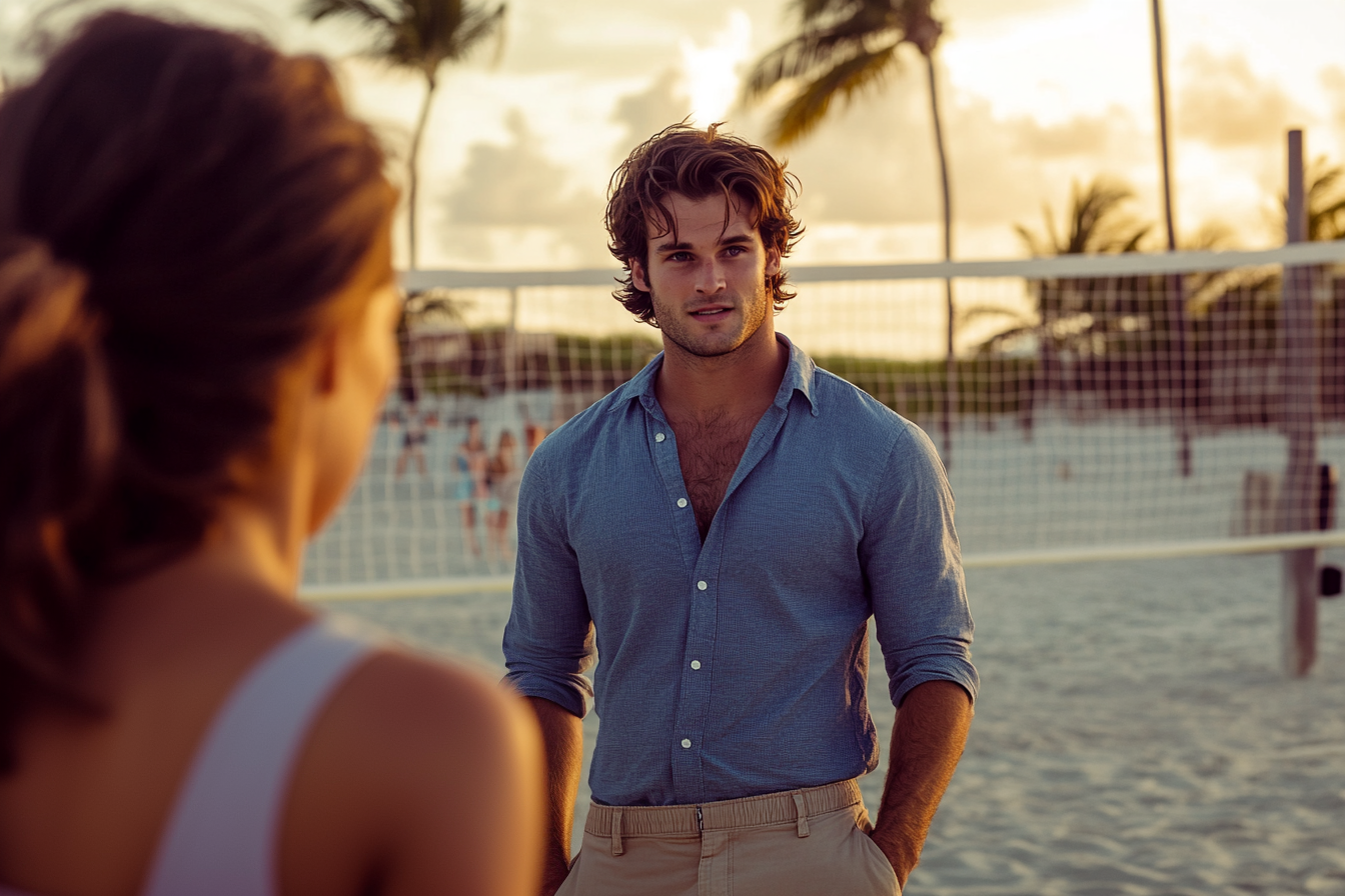 Homme d'une trentaine d'années parlant à une femme près d'un terrain de volley-ball sur une plage de sable | Source : Midjourney