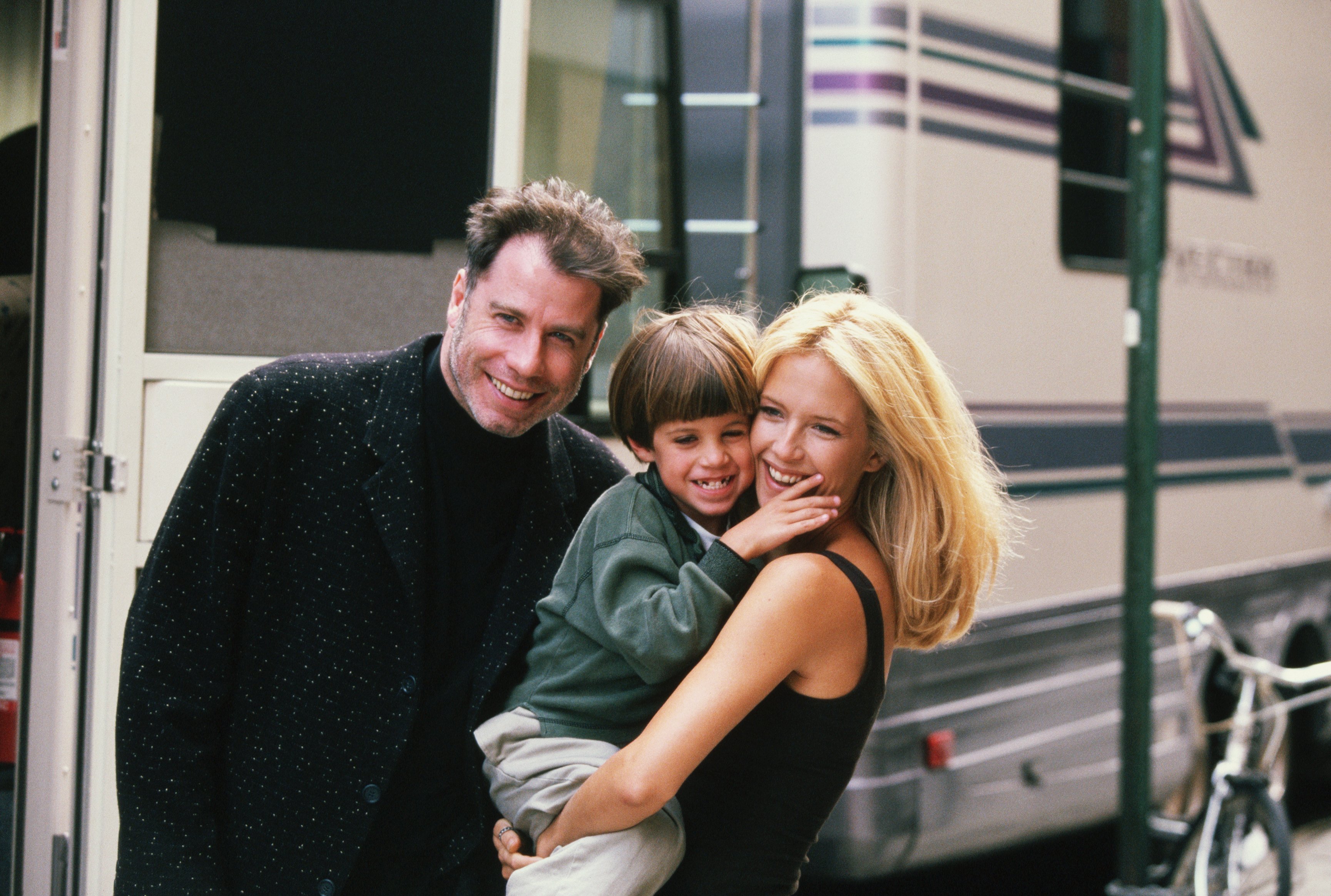L'actrice Kelly Preston reçoit la visite de son mari John Travolta (à gauche) et de son fils Jett lors du tournage du film "Addicted to Love" en 1997. | Source : Getty Images