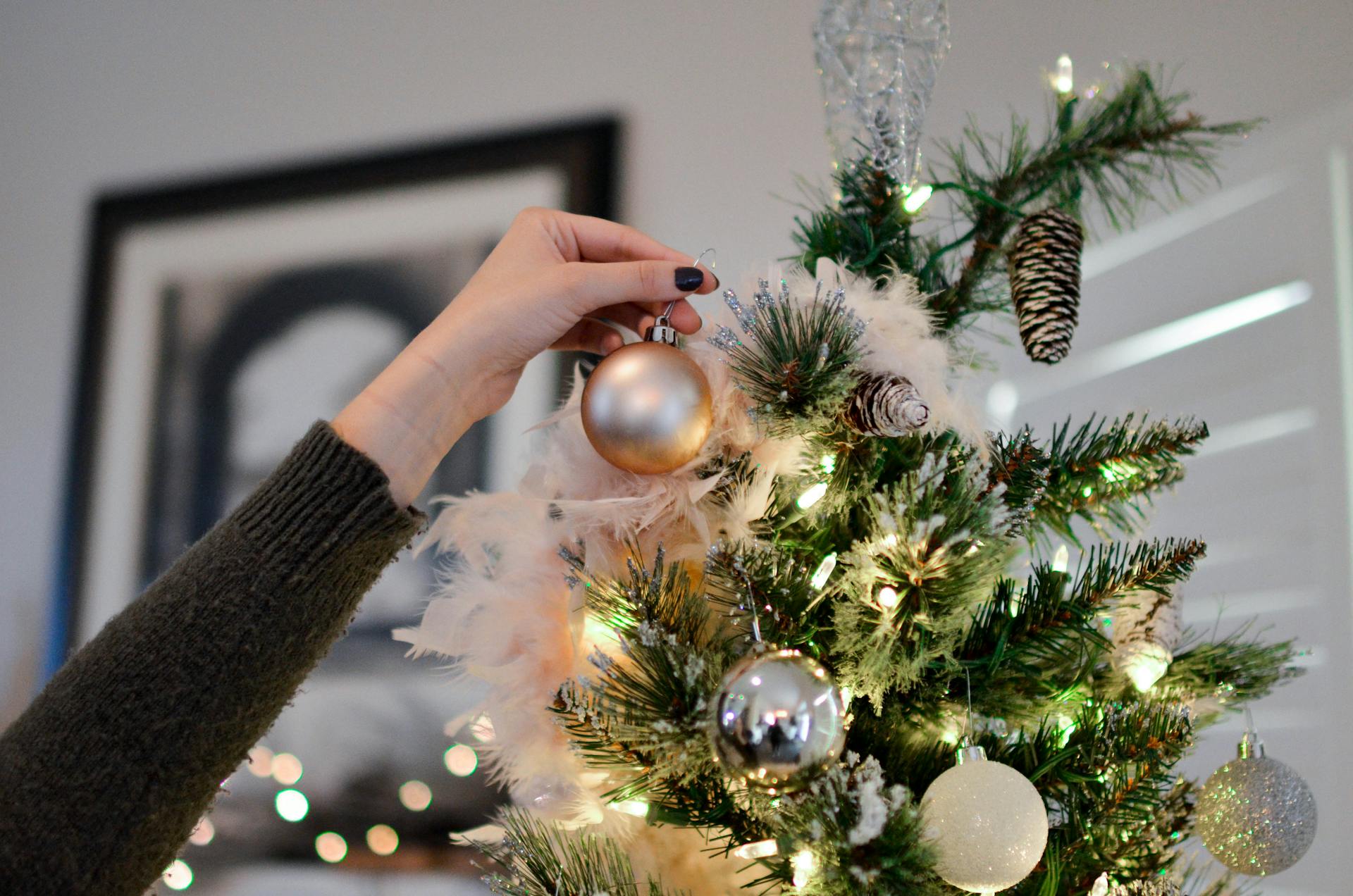 Une femme décorant un arbre de Noël | Source : Pexels