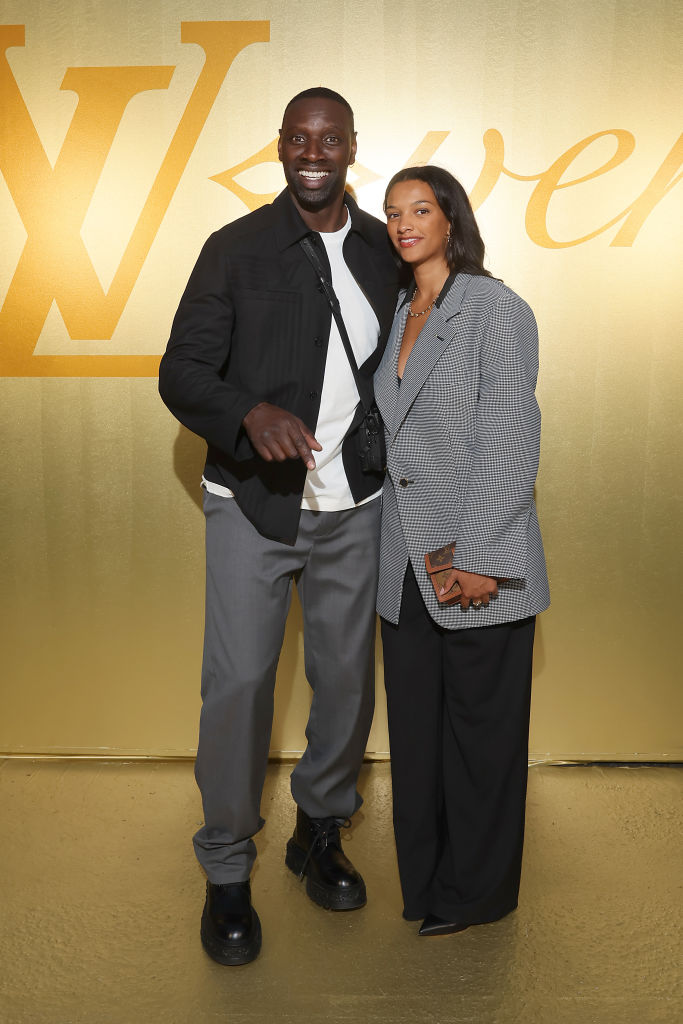 Omar Sy et Selly Sy assistent au défilé Louis Vuitton Homme Printemps/Été 2024 dans le cadre de la Fashion Week de Paris le 20 juin 2023 à Paris, France | Source : Getty Images