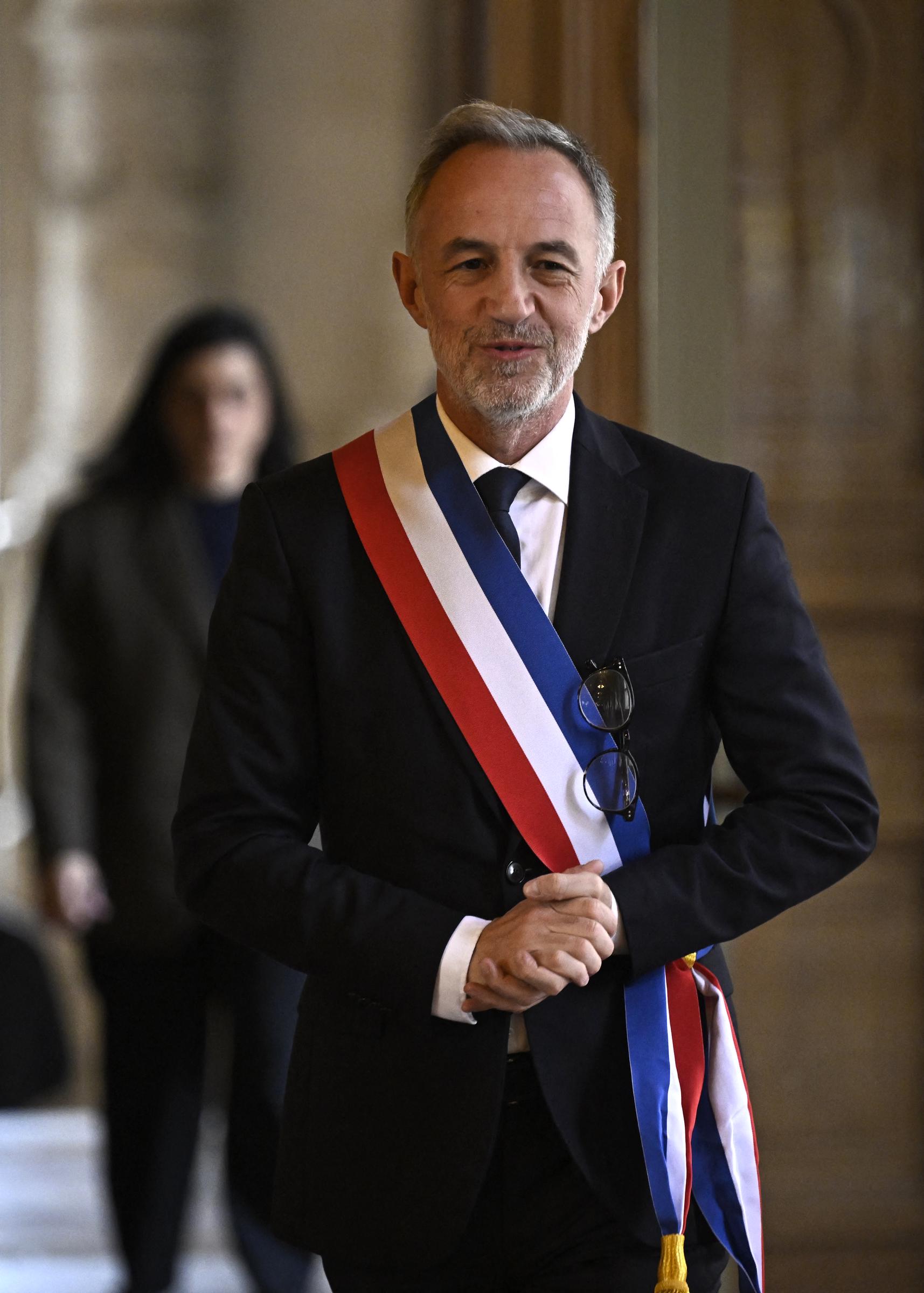 Emmanuel Grégoire, le nouveau maire de Paris, arborant son écharpe tricolore, s'adresse aux journalistes à l'issue de la première séance du conseil municipal à l'Hôtel de Ville de Paris, le 29 mars 2026 I Source : Getty Images