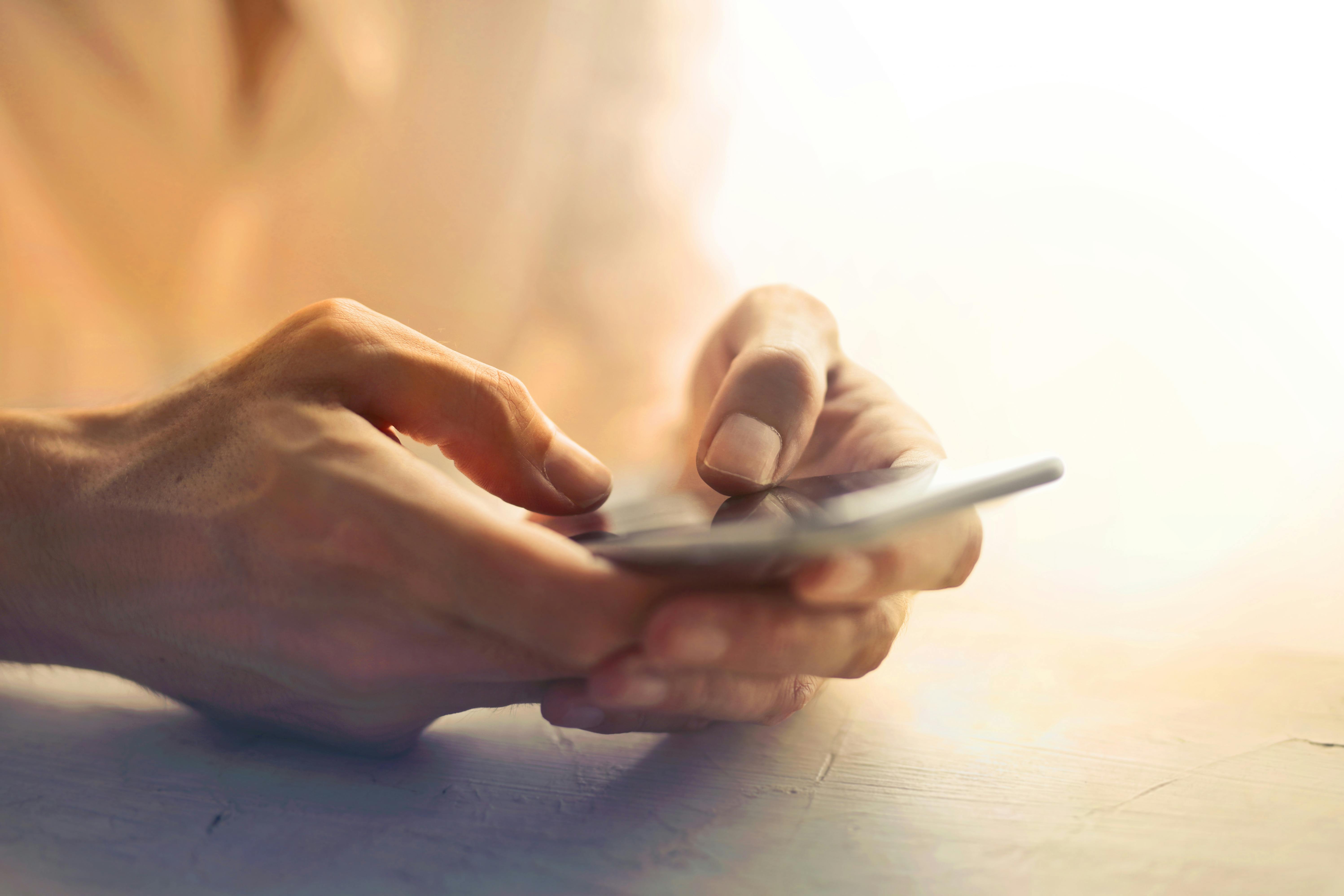 Woman's hands holding a phone | Source: Pexels