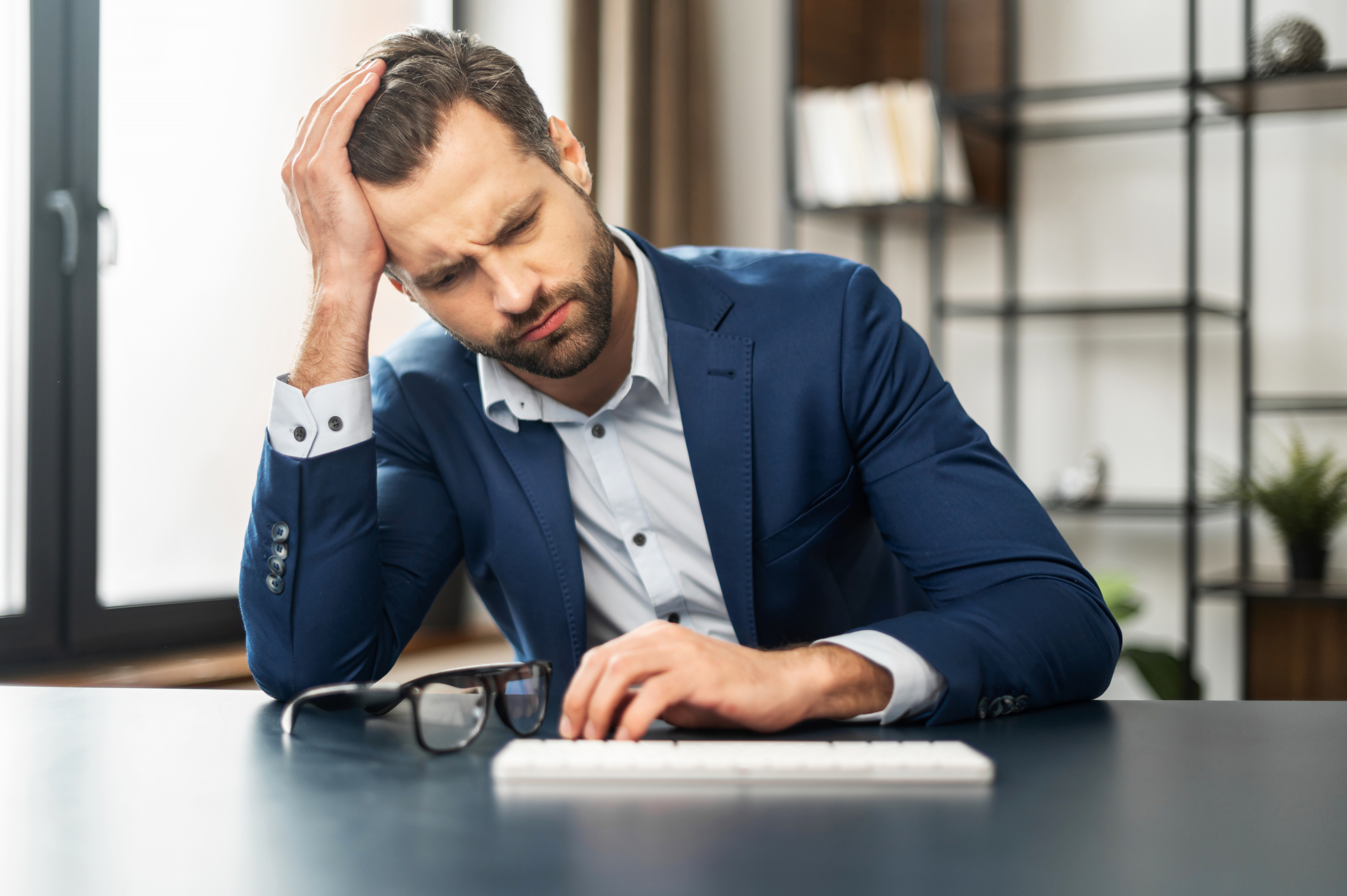 Homme stressé au travail | Source : Shutterstock