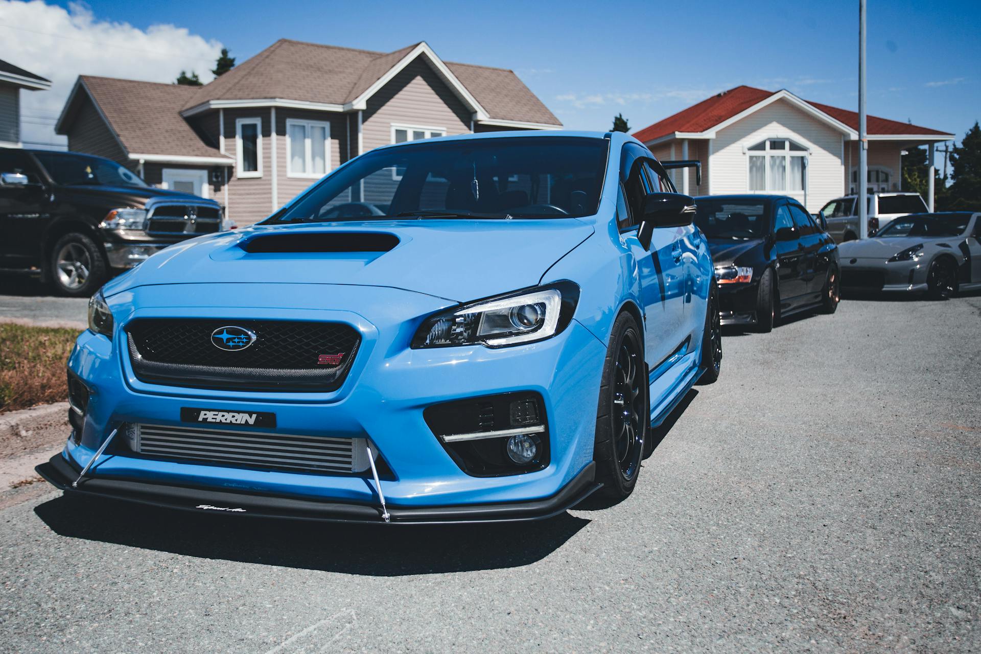 A blue sedan parked on the sidewalk in a suburban neighborhood | Source: Pexels