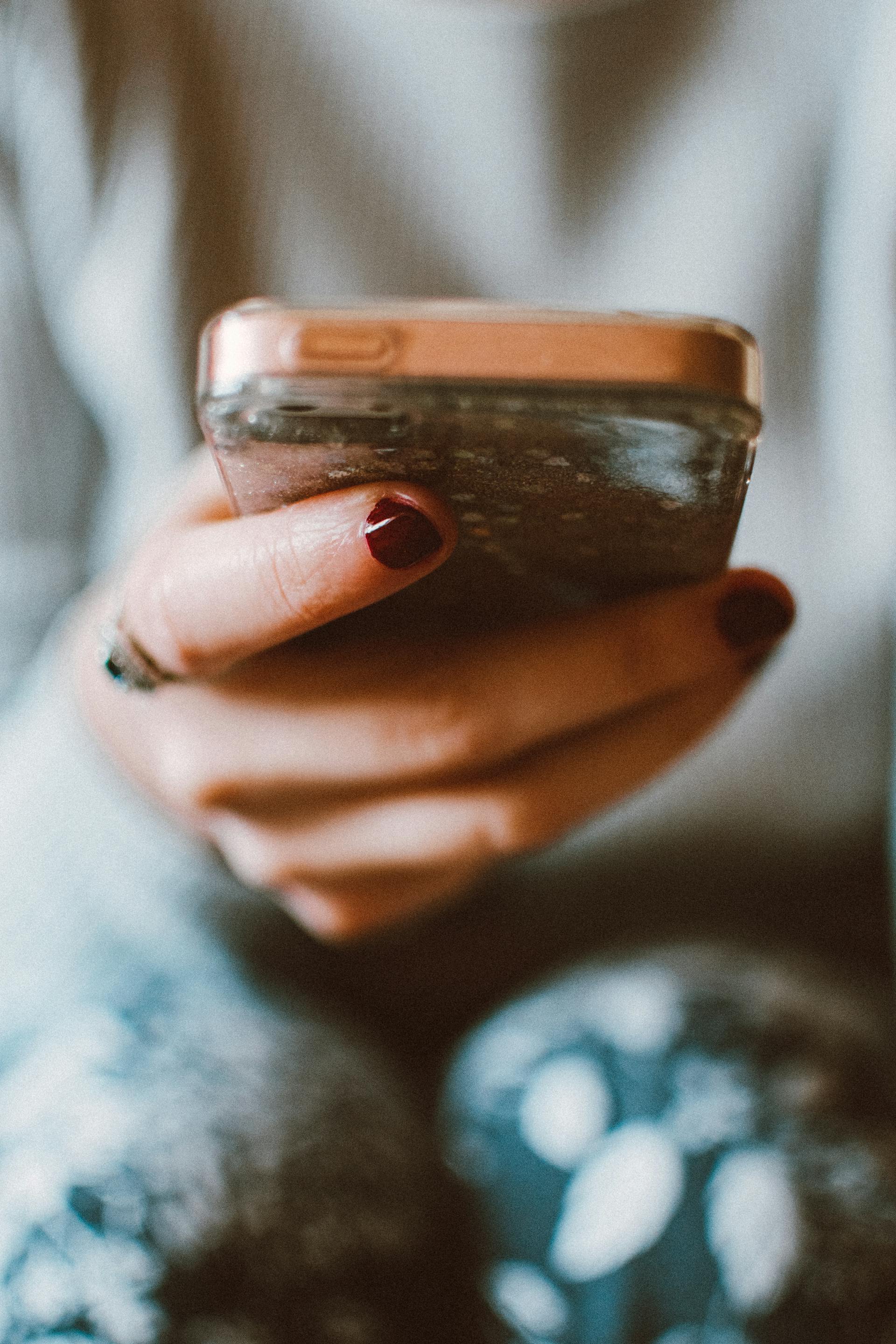 Une femme tenant son téléphone portable | Source : Pexels