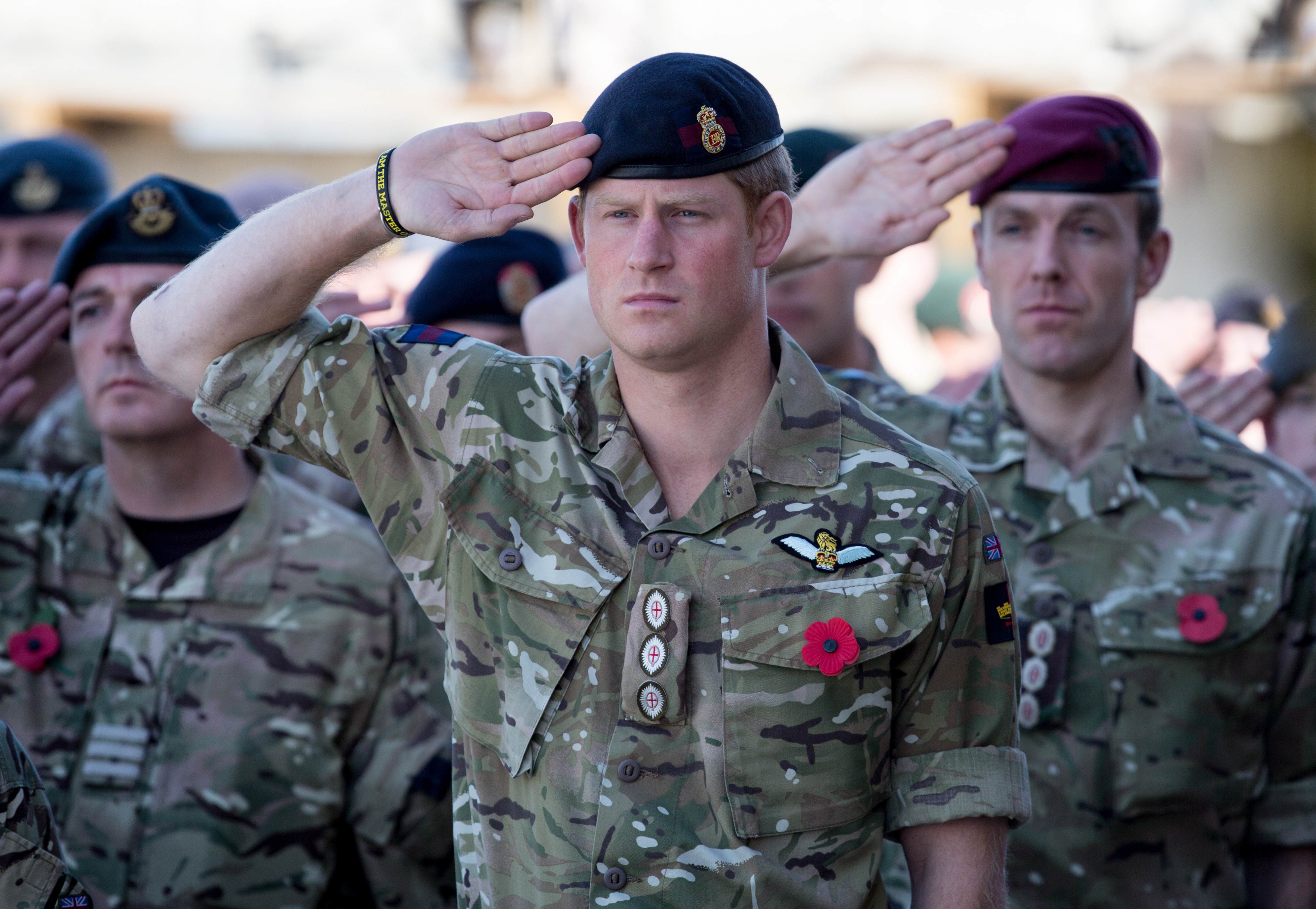 Le prince Harry salue alors que la Dernière sonnerie est jouée lors d'un service du dimanche du Souvenir à l'aérodrome de Kandahar, le 9 novembre 2014 à Kandahar, en Afghanistan. | Source : Getty Images