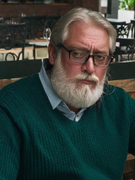 An old man in a restaurant, looking remorseful | Source: Midjourney