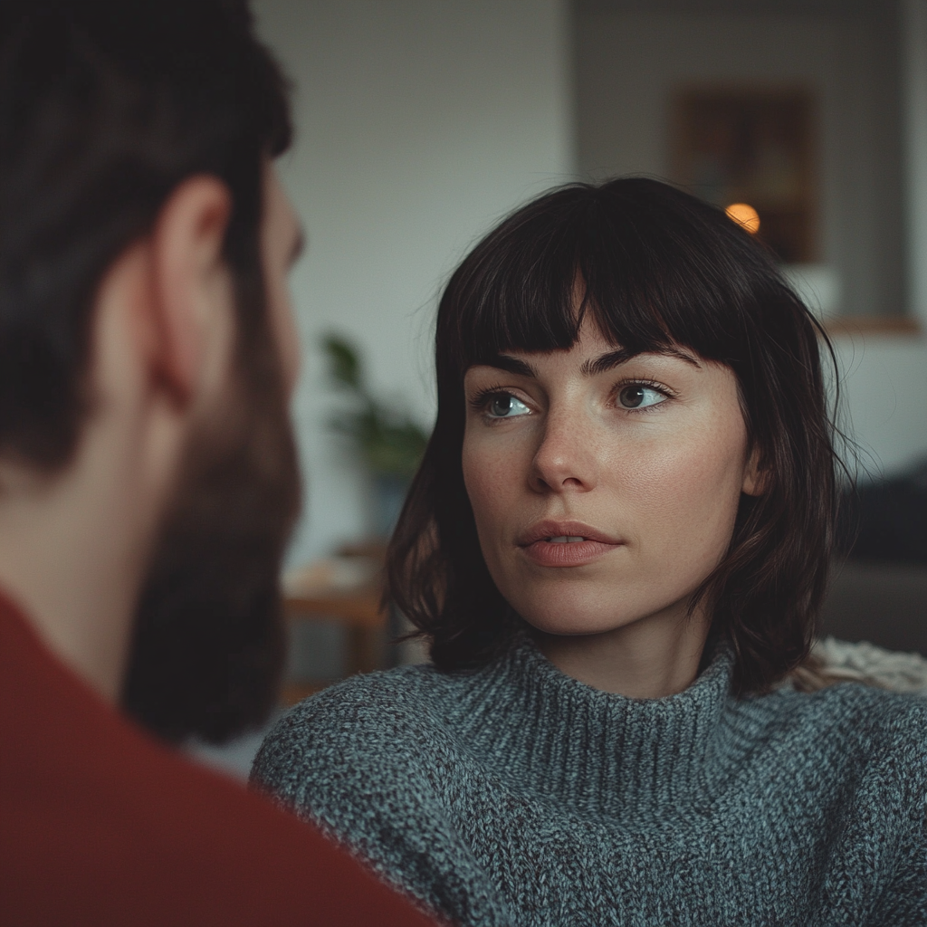 Une femme sérieuse qui parle à un homme dans son salon | Source : Midjourney