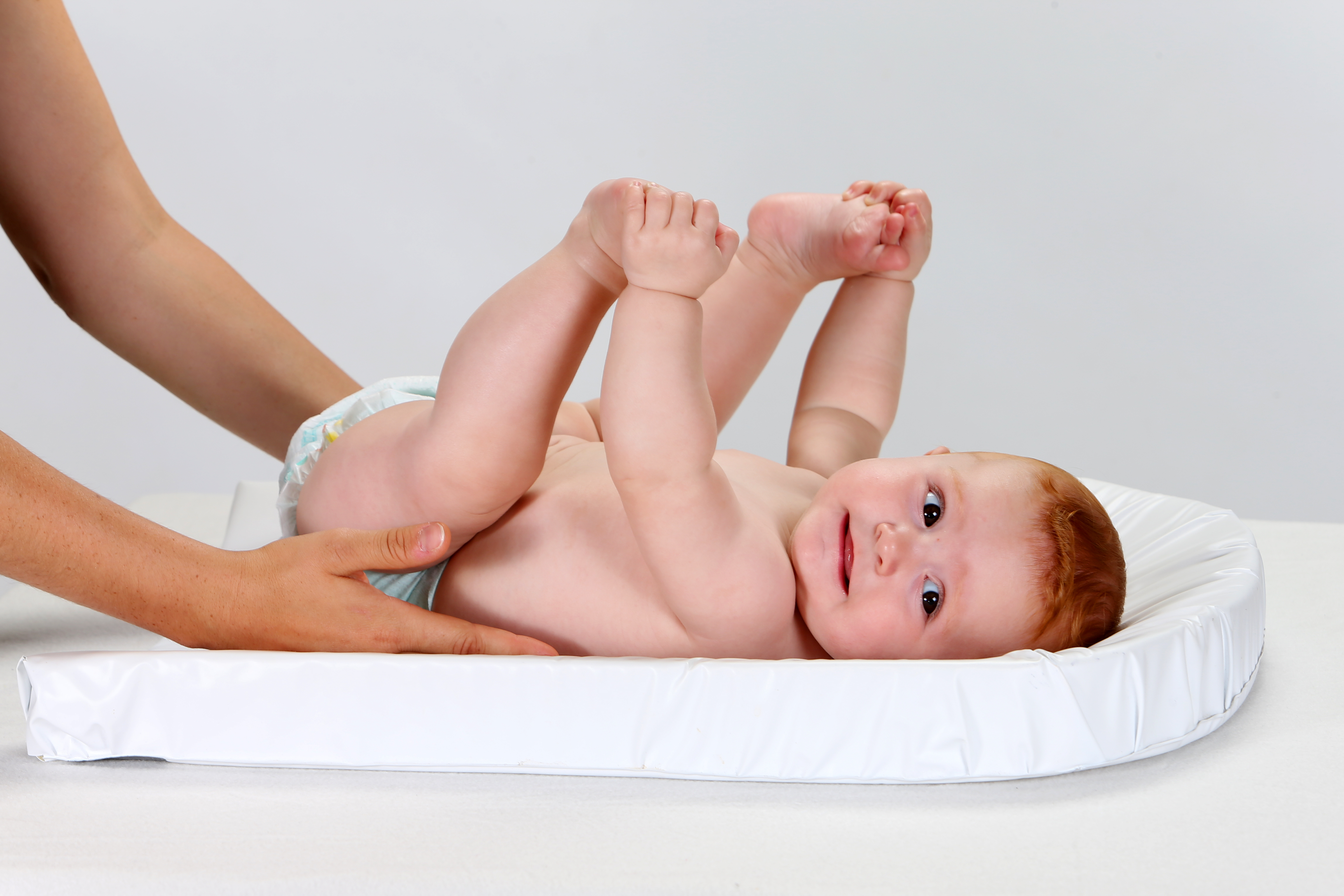 Uma mulher segurando um bebê em uma fralda | Fonte: Shutterstock