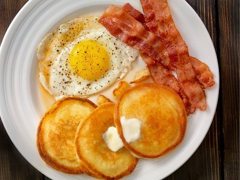 Petit déjeuner: pancakes, bacon et œufs | Photo: Getty Images